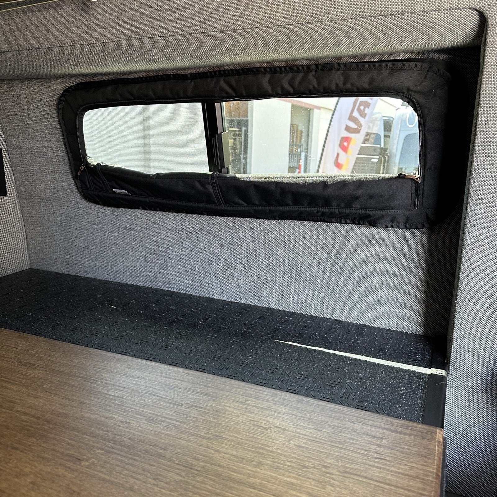 Canyon Adventure Vans CLIMA-SHADE™ insulated bunk window cover installed in a van for temperature control and privacy.