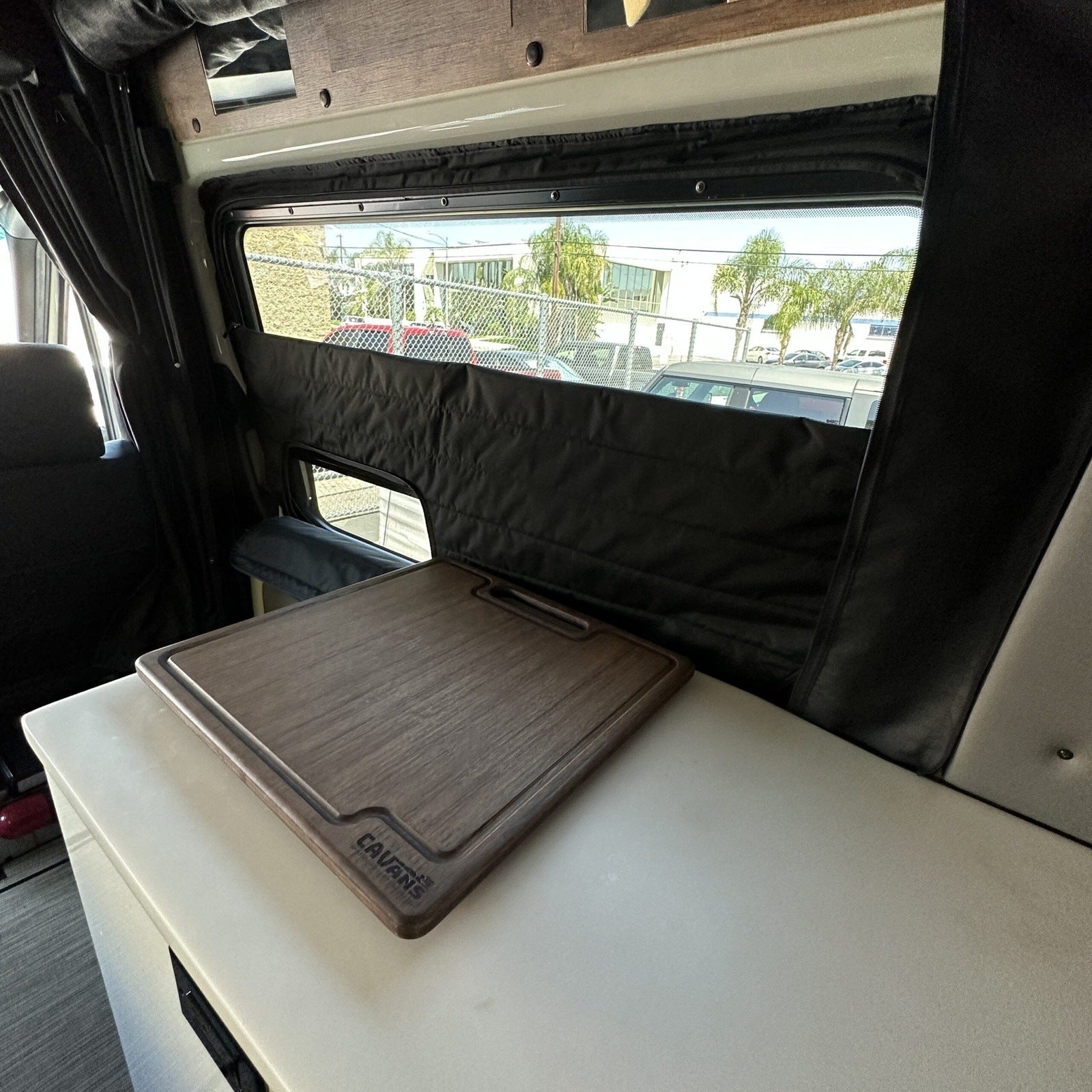 Canyon Adventure Vans CLIMA-SHADE insulated sliding door window cover on Storyteller Overland Mode van, showing installation details.