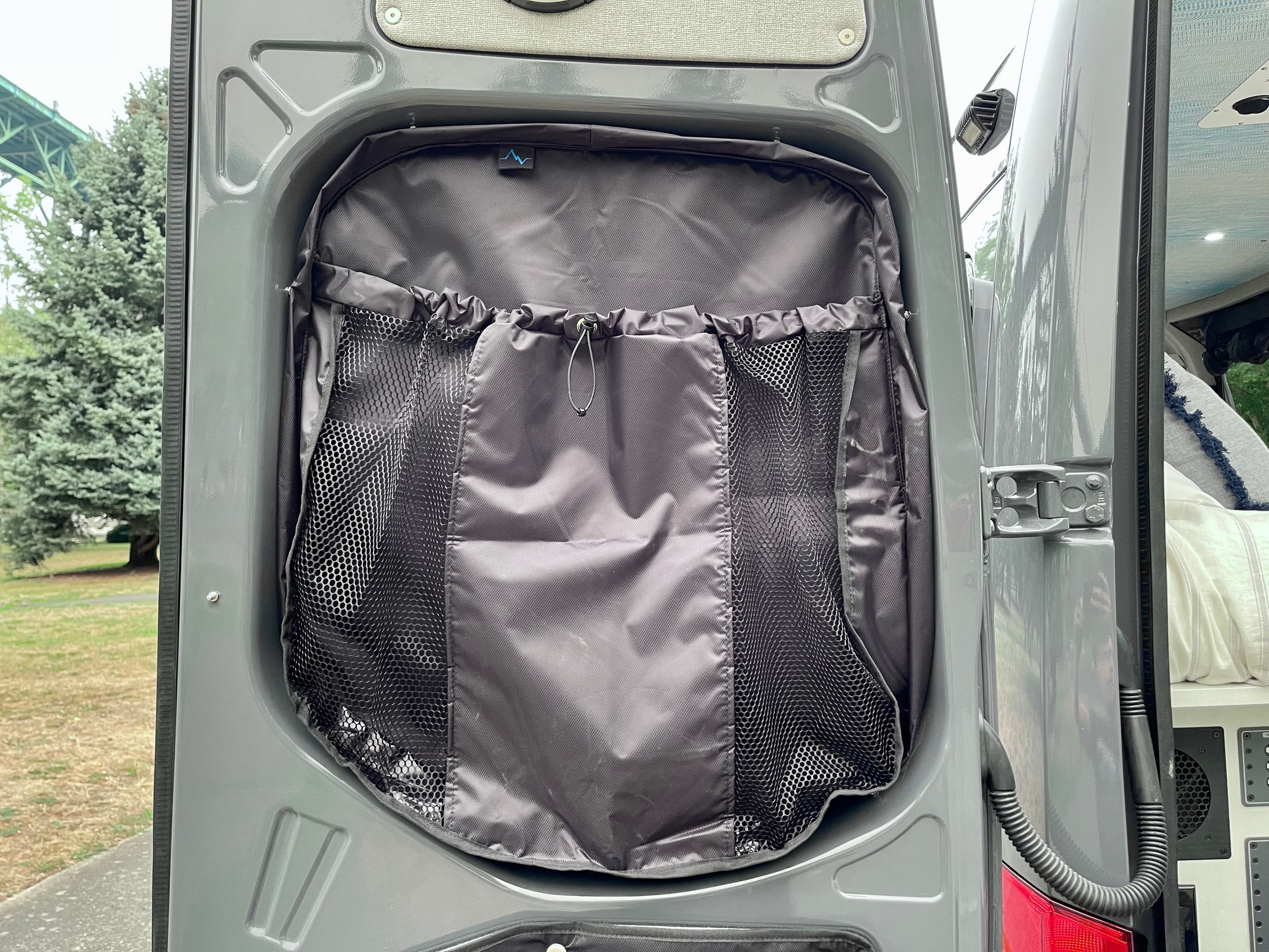 Alpine Van Works AVW Mid-Door Bags for storage solutions, shown installed inside vehicle door with organized compartments.
