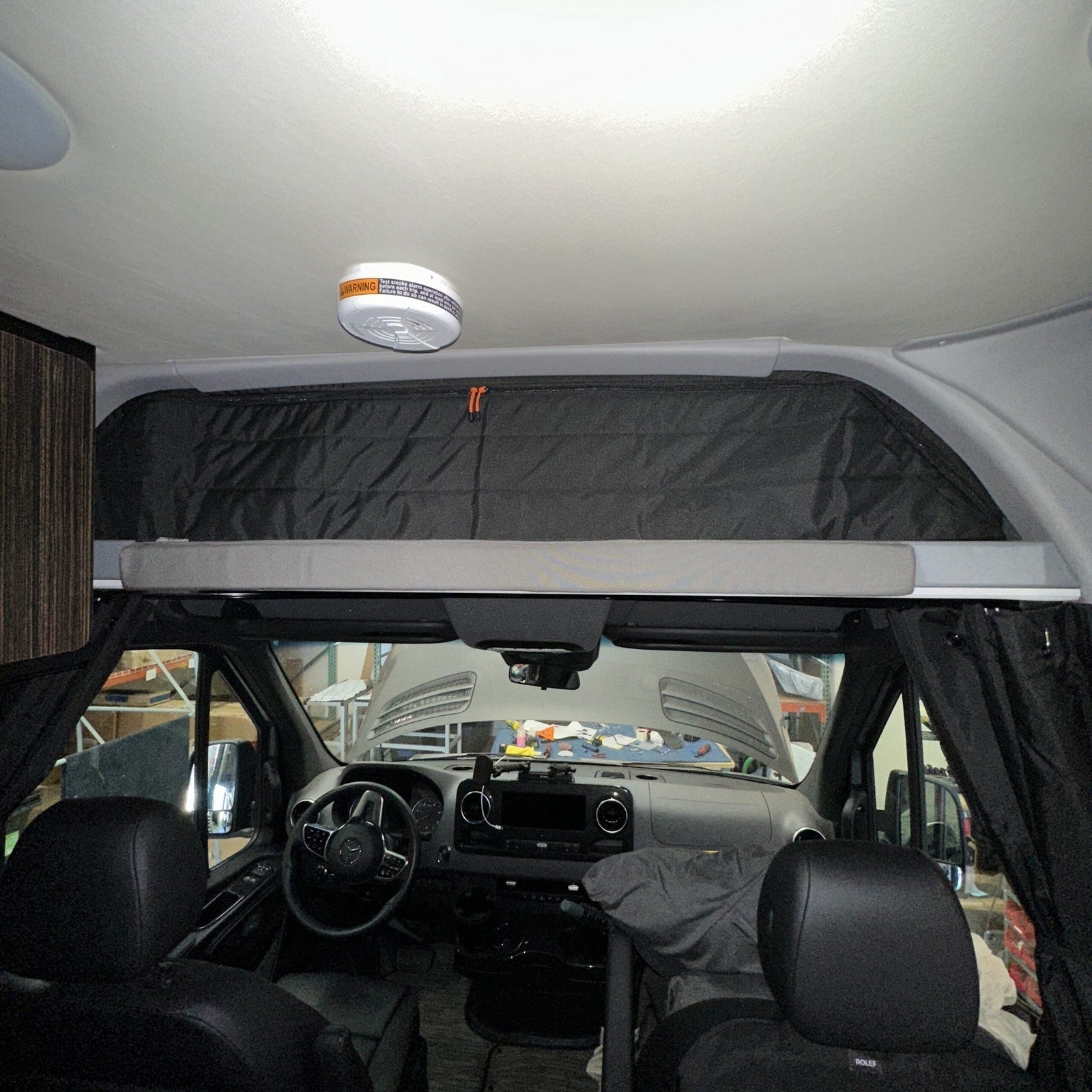 Canyon Adventure Vans CLIMA-SHADE™ insulated cab shelf cover in use, showcasing its protective and stylish design.