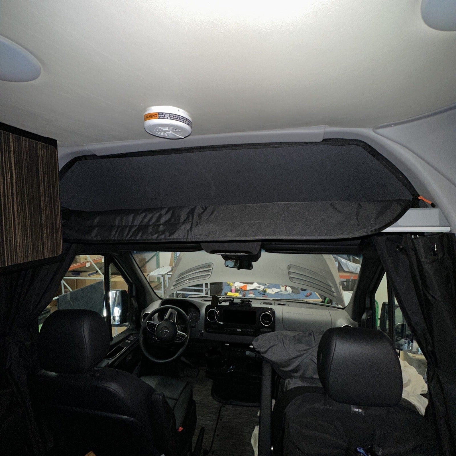 Canyon Adventure Vans CLIMA-SHADE™ insulated cab shelf cover in a vehicle interior, showcasing insulation and fit.