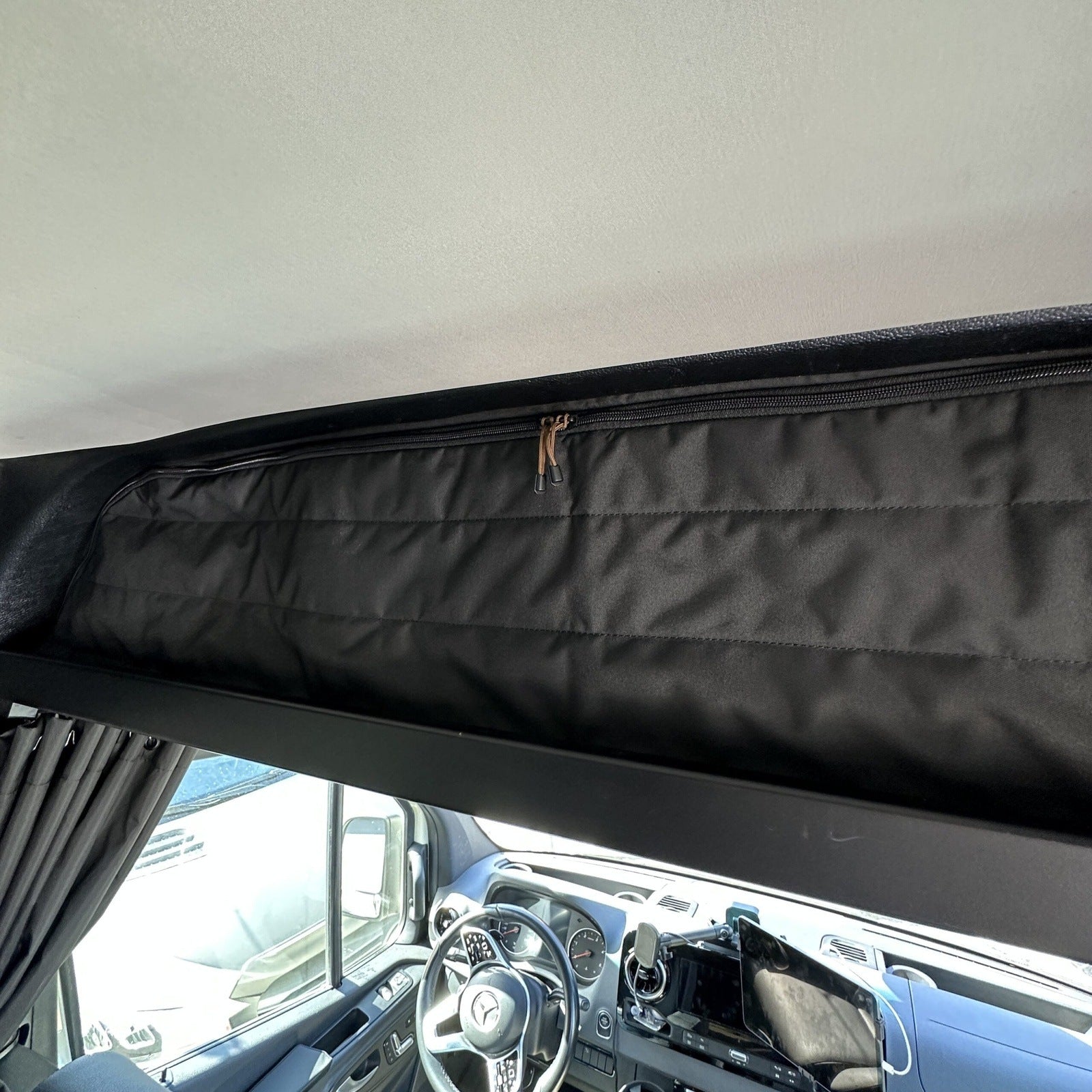 Canyon Adventure Vans CLIMA-SHADE™ insulated cab shelf cover in a vehicle, showcasing its fit and insulation features.