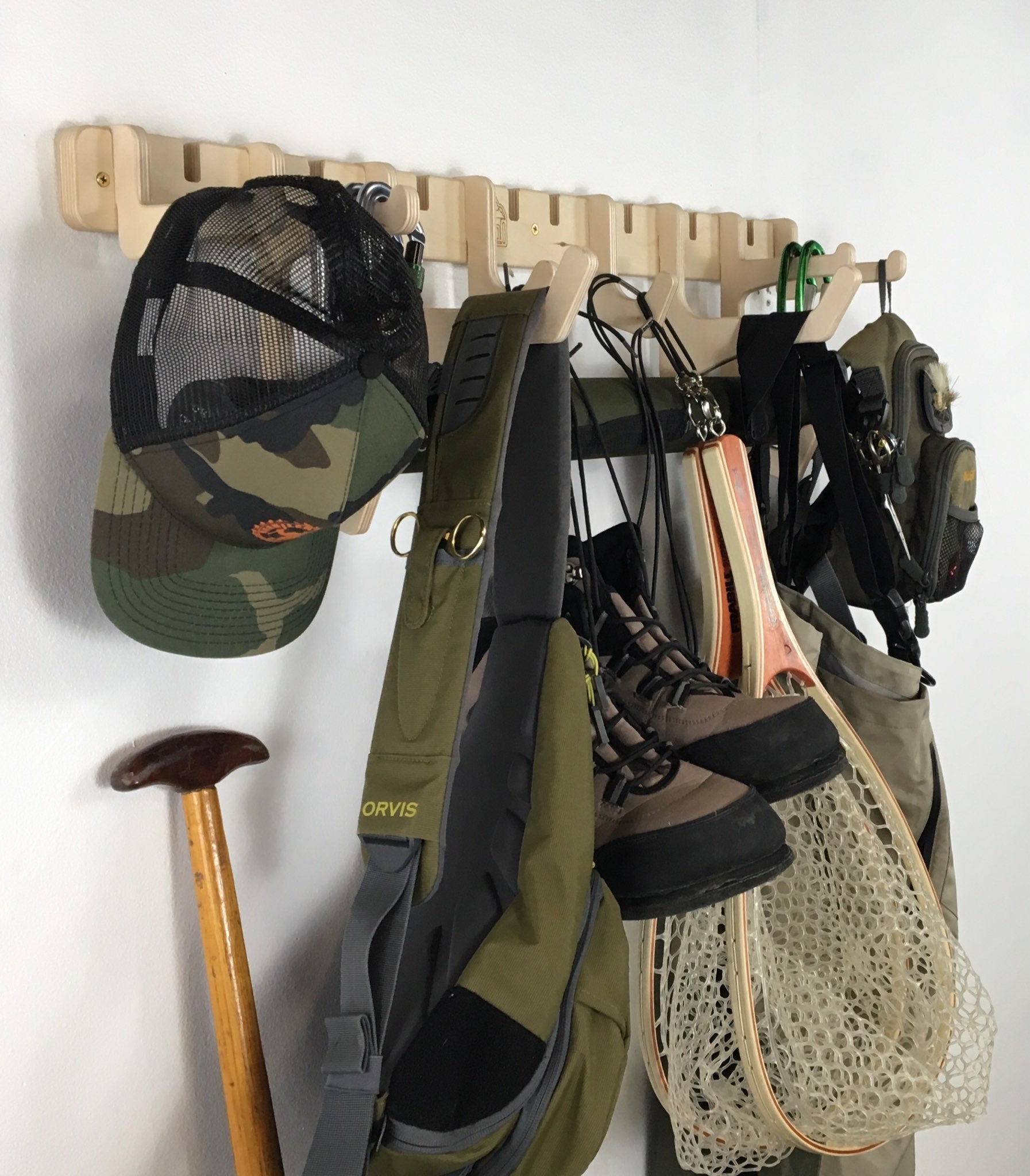 Rado Racks Jetty fishing gear rack holding fishing rods and tackle boxes, wall-mounted storage for fishing accessories.