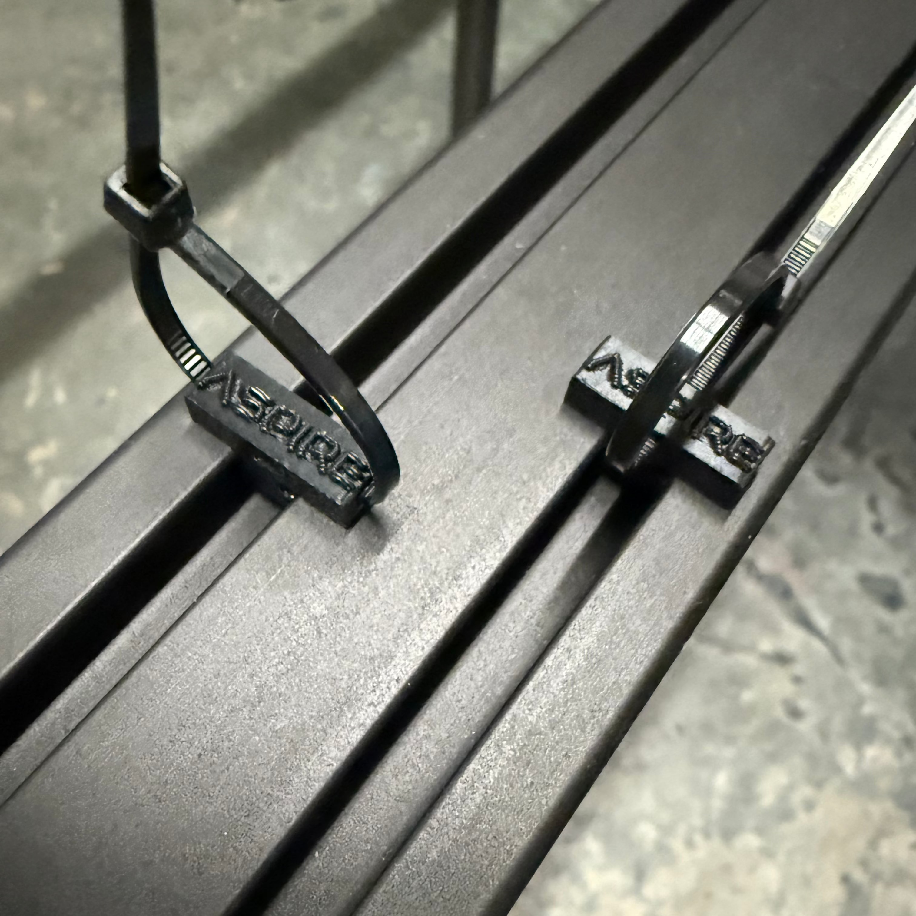 Aspire Auto Accessories wire management zip-tie holders for roof racks, securing cables neatly and safely on vehicle roof racks.