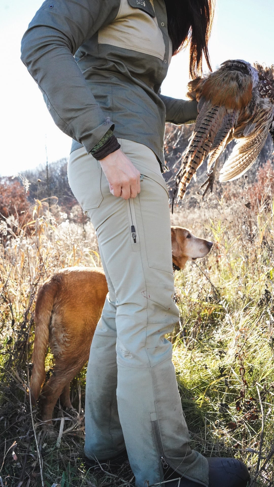 Dark green Kortni Upland Pant by DSG OUTERWEAR, featuring a relaxed fit and outdoor-ready style, shown on a hanger.