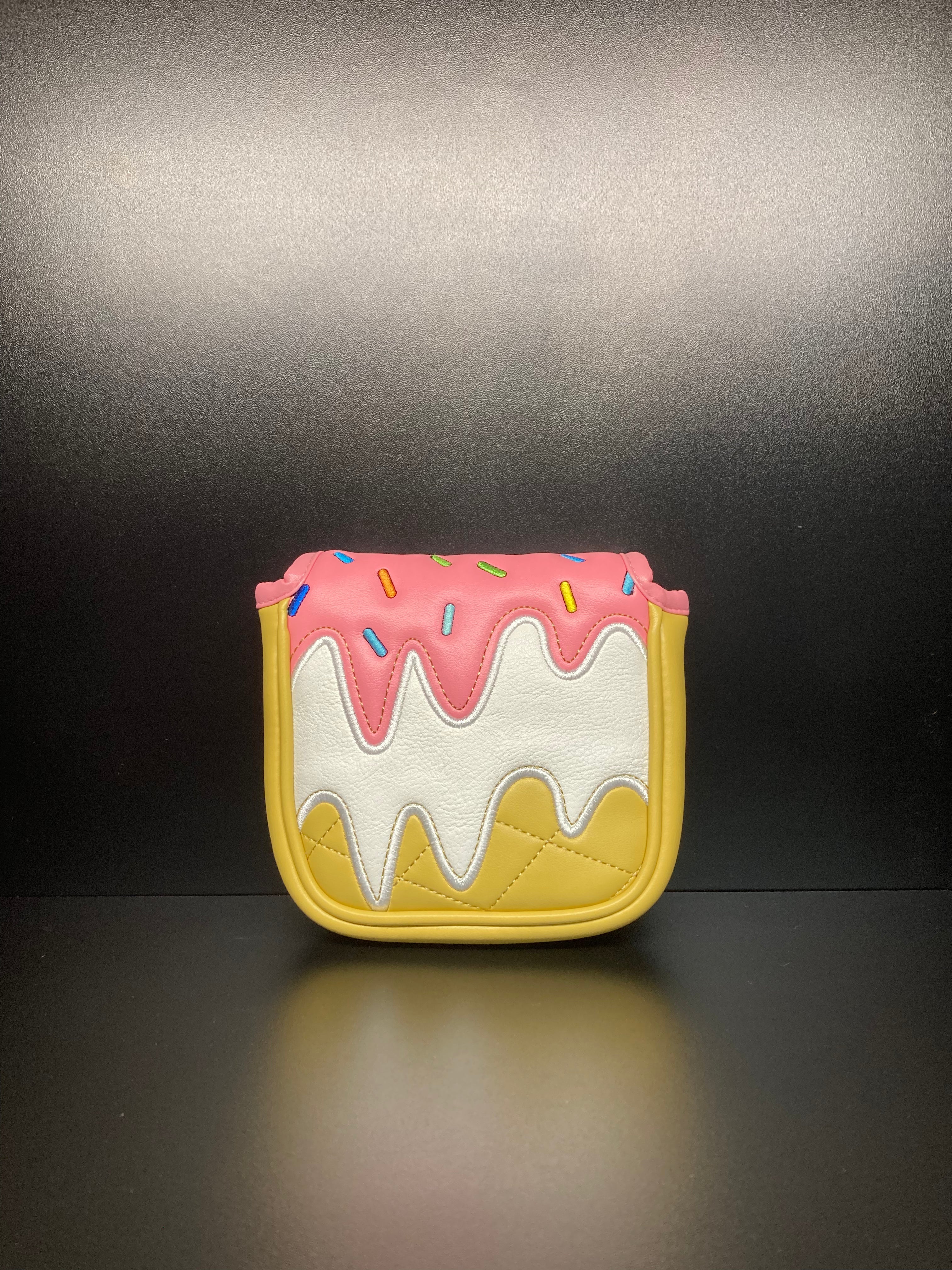 ParWestGolf ice cream cone golf club headcover resting on a golf bag, colorful and playful design for club protection.