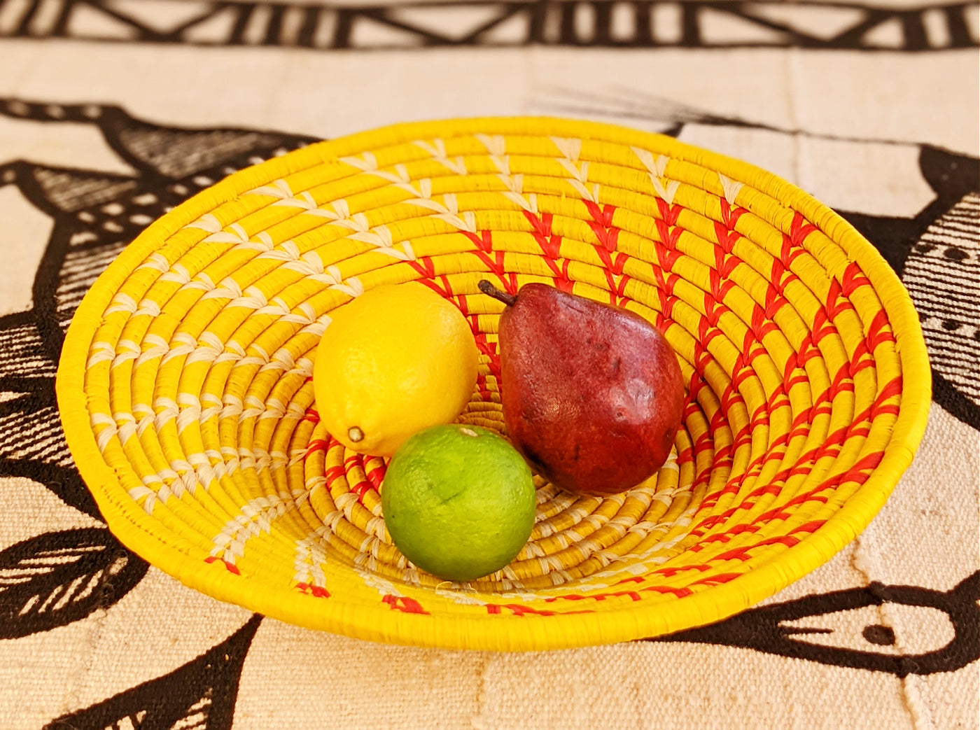 Large yellow woven African basket by Reflektion Design, showcasing intricate handwoven patterns and vibrant color.