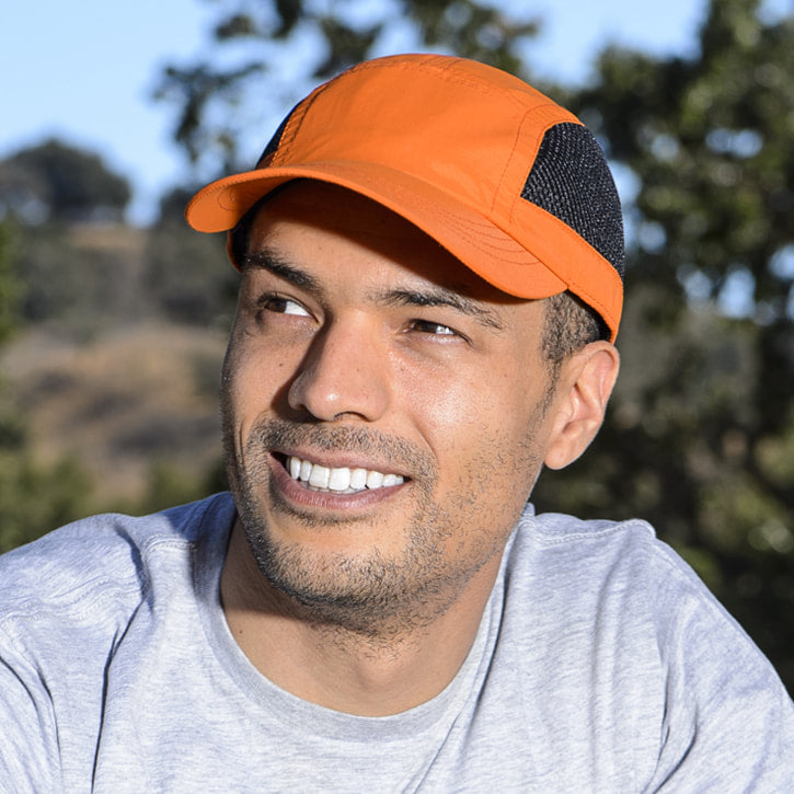 Juniper Outdoor jogger cap in black, featuring a curved brim and adjustable strap for outdoor athletic activities.