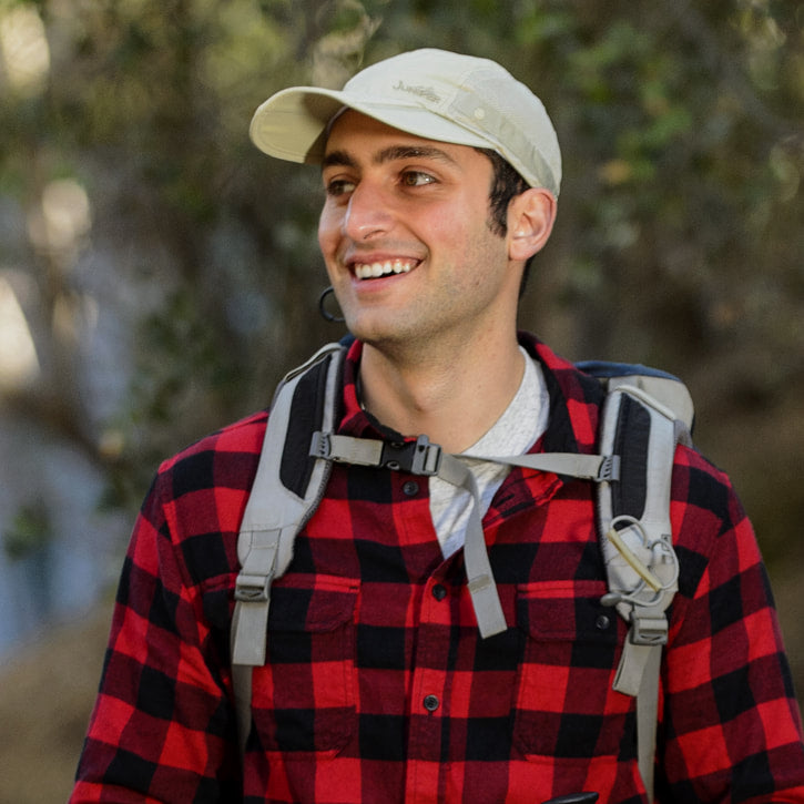 Juniper Outdoor Canyon Cap, a stylish outdoor hat in a natural color, featuring a curved brim and adjustable strap.