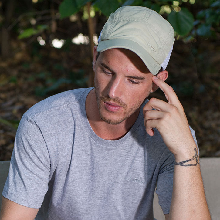 Juniper Outdoor Lair Cap in a physical style, featuring a structured design with adjustable strap and logo embroidery.