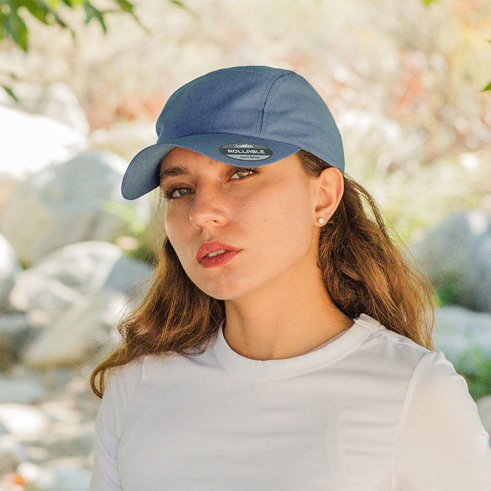 Juniper Outdoor rollable UV biker's cap, lightweight and adjustable, shown in navy blue with a curved brim and breathable fabric.