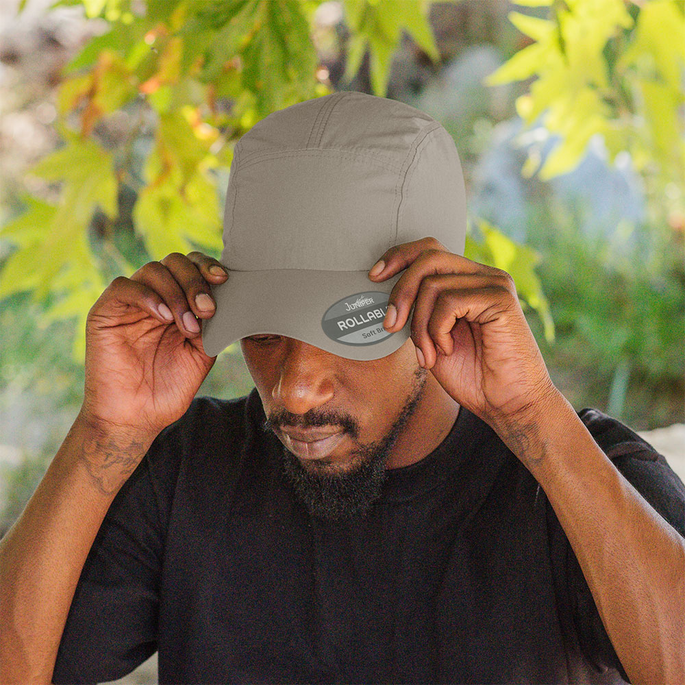 Juniper Outdoor rollable UV biker's cap shown in black, featuring a wide brim and adjustable strap for outdoor protection.