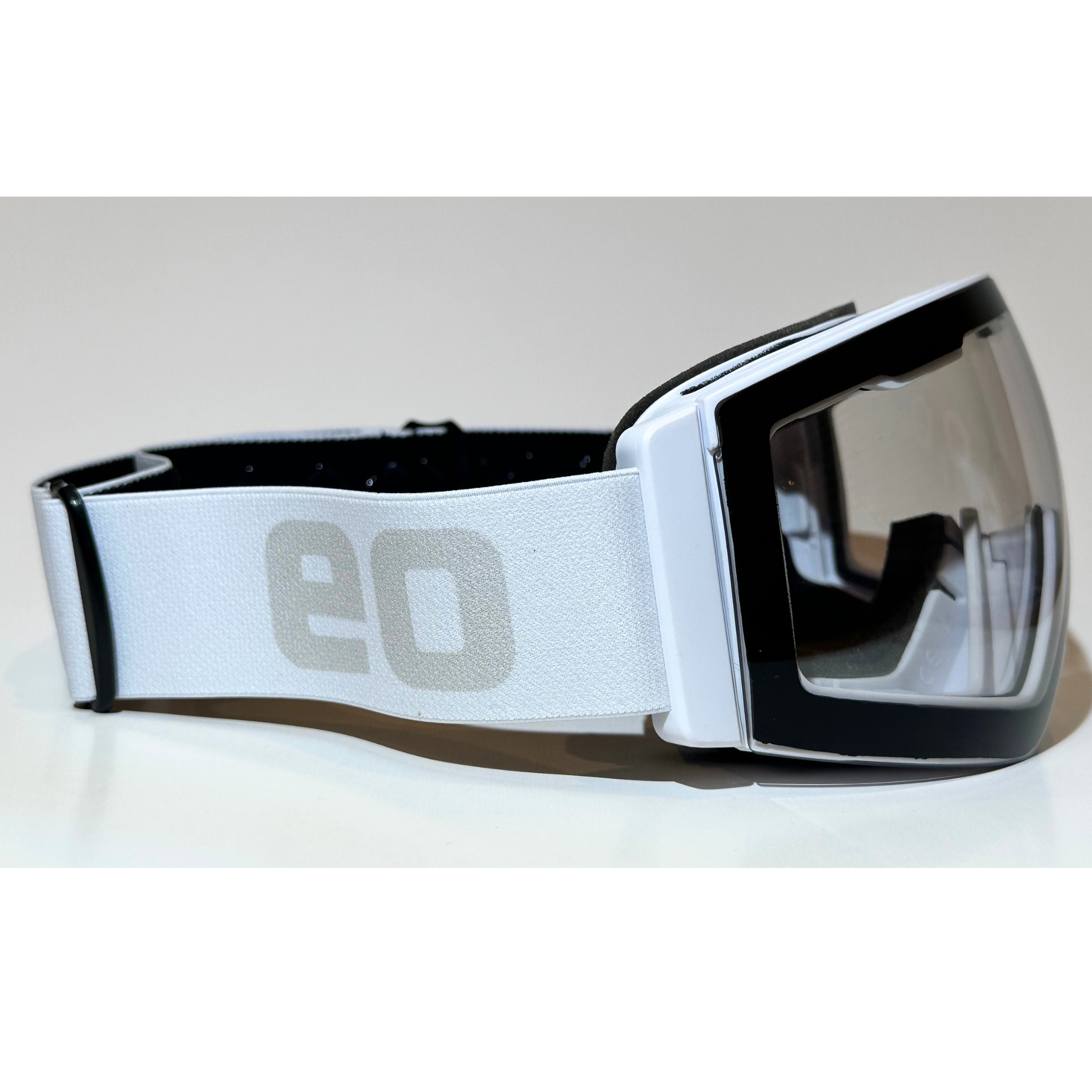 Eastern Outer MACH SCHNELL MAG photochromic ski and snowboard goggles with white frame and clear side lenses.