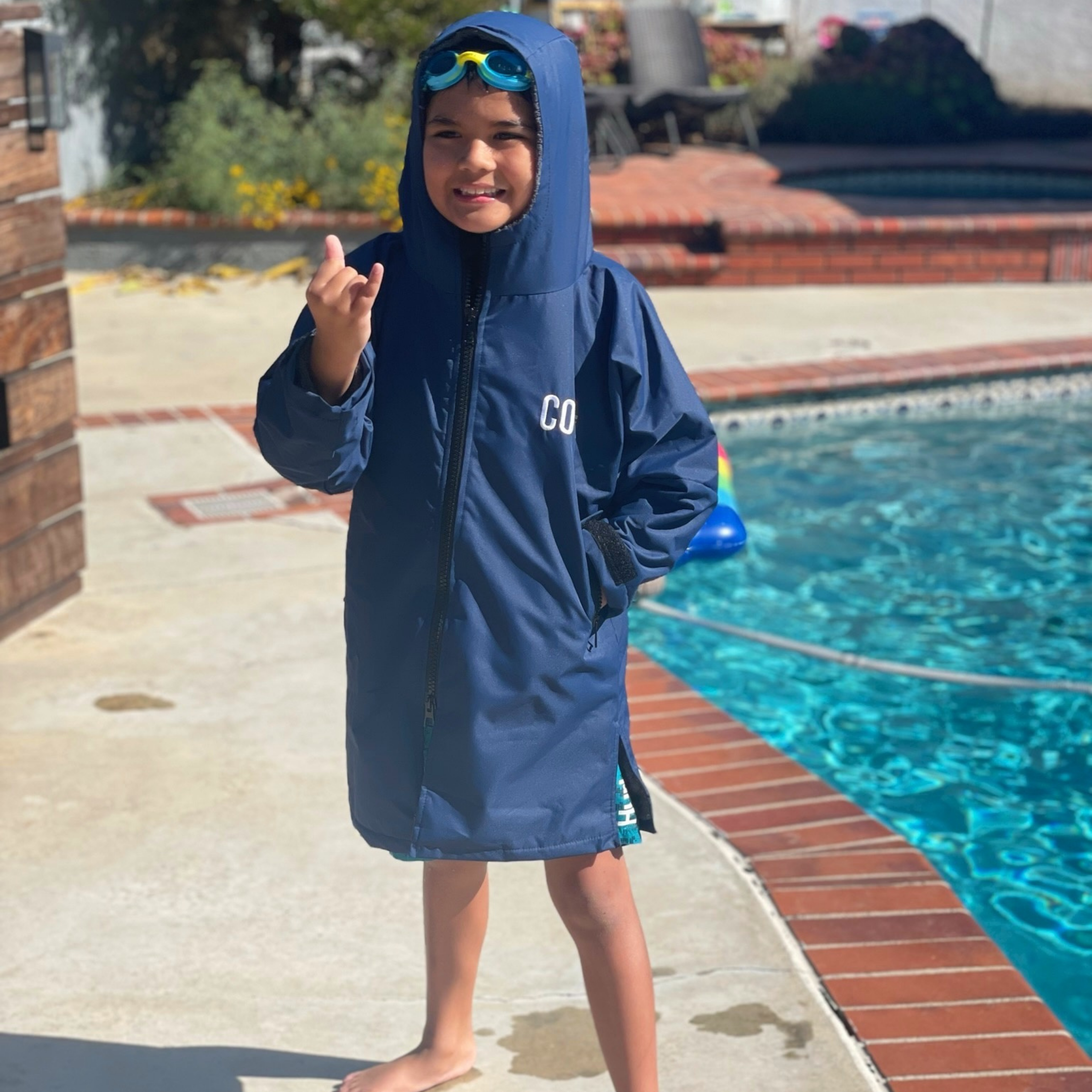 Kids COR Surf swim parka jacket for ages 4-8, lightweight waterproof outerwear with hood and front pockets for outdoor water activities.