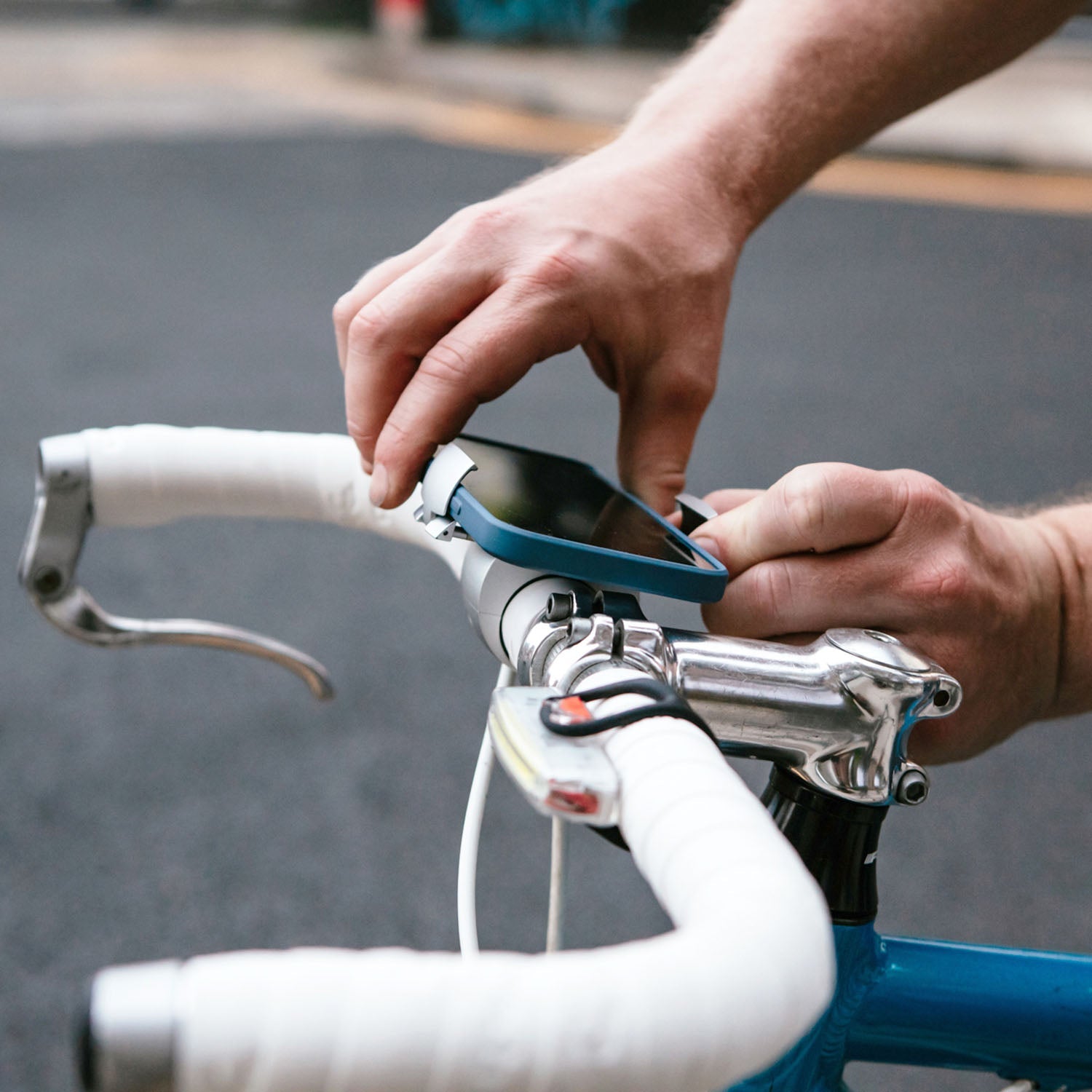ZEITBIKE Loop Mount universal bicycle phone mount attached to bike handlebar, holding a smartphone securely during a ride.