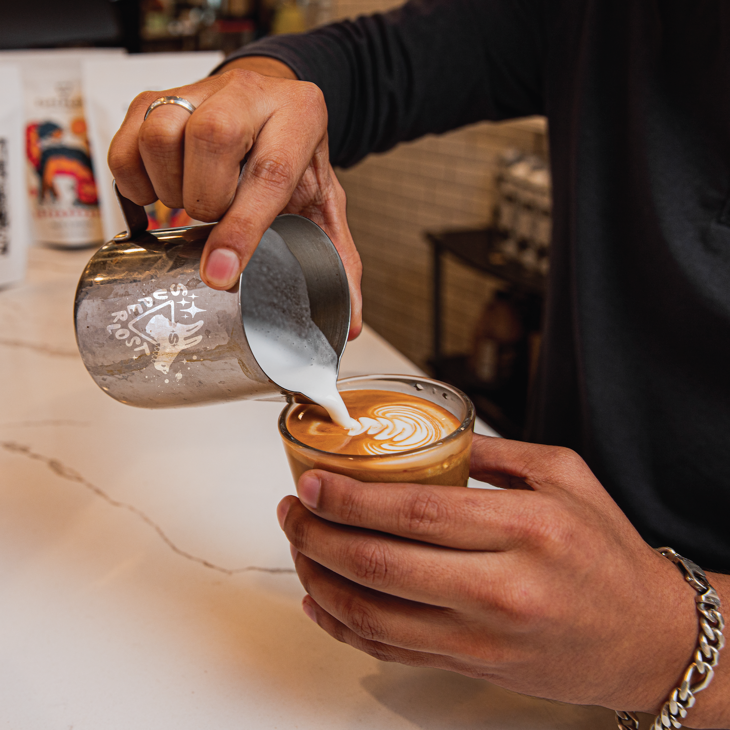 Latte art featuring a starburst design on a Superlost Coffee Supernova Espresso coffee in a ceramic cup.