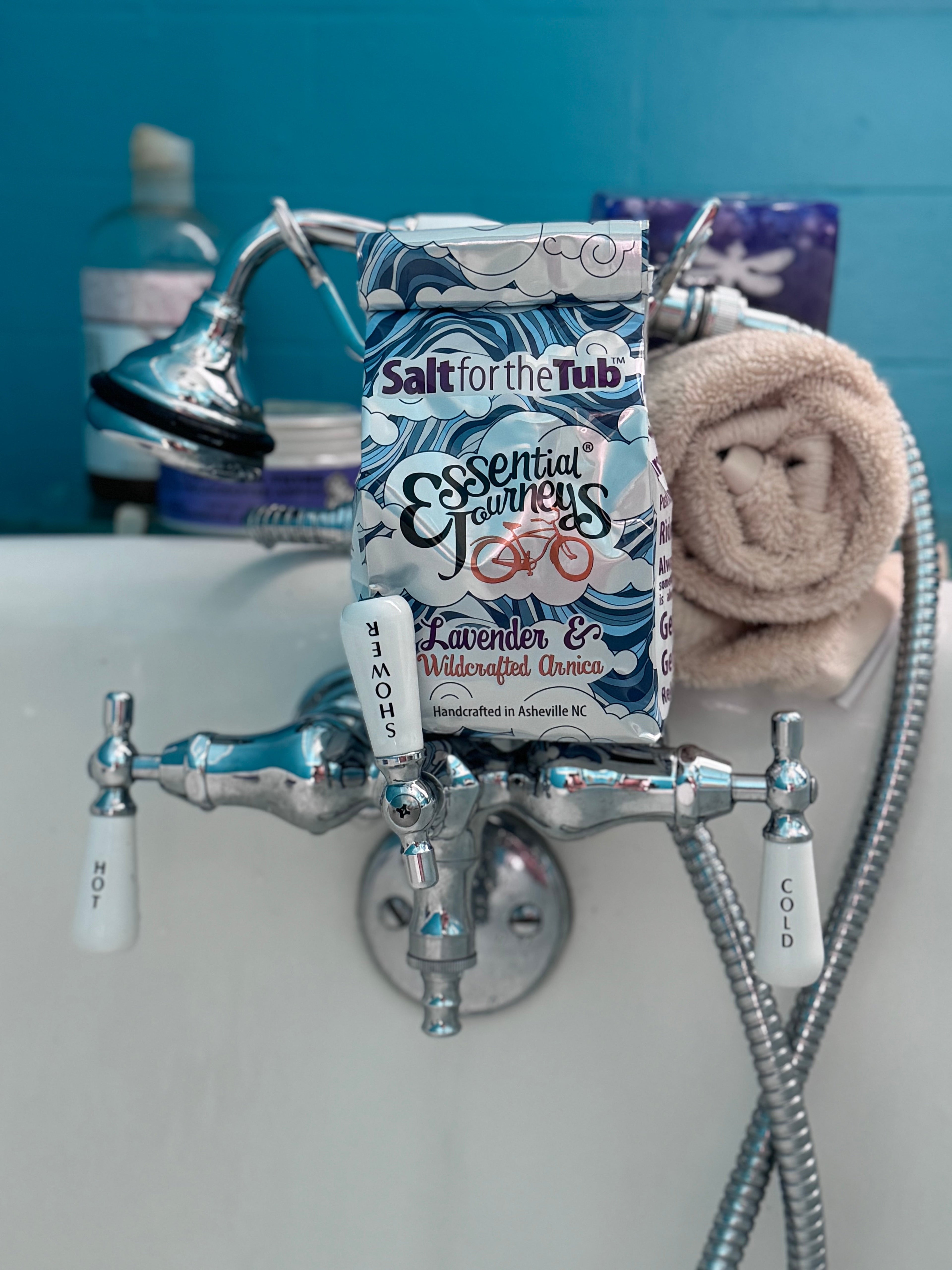 Lavender and arnica bath salts in a tub, natural essential journey brand, relaxing spa treatment for soothing bath experience.