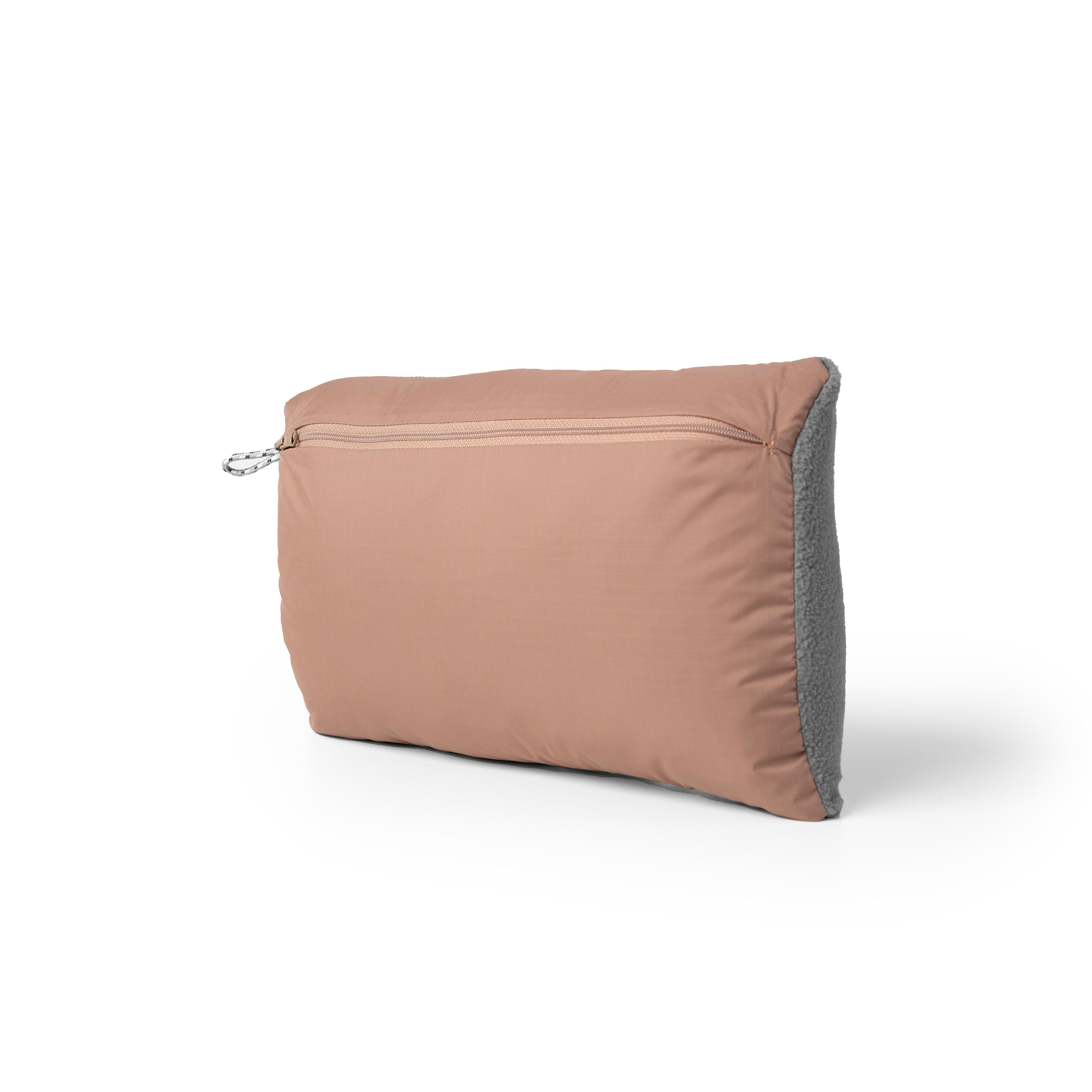 Gravel Layover™ XL travel blanket with pillow pocket in stylish quartz color, shown folded and partially unrolled.