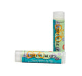 Essential Journeys Coasting Coconut SPF 15 Lip Lube™ showing a coconut-scented lip balm in a sleek container.