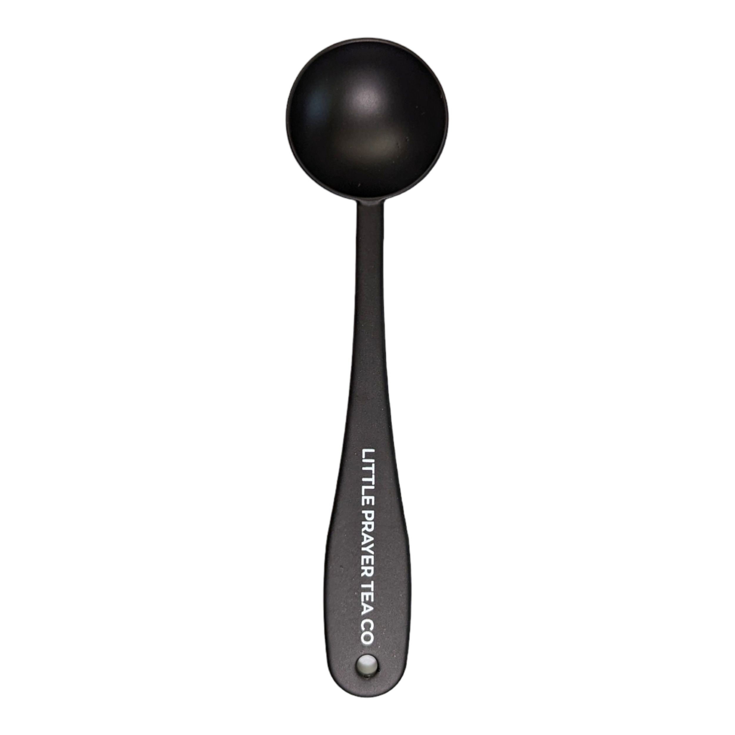 Little Prayer Tea Spoon with delicate design, perfect for stirring tea, featured in a soft light setting.