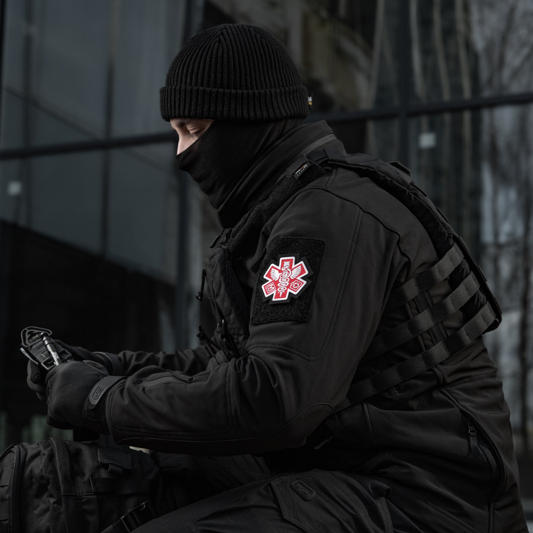 Embroidered M-Tac Paramedic patch in black, featuring a detailed medical symbol design for uniforms or gear.