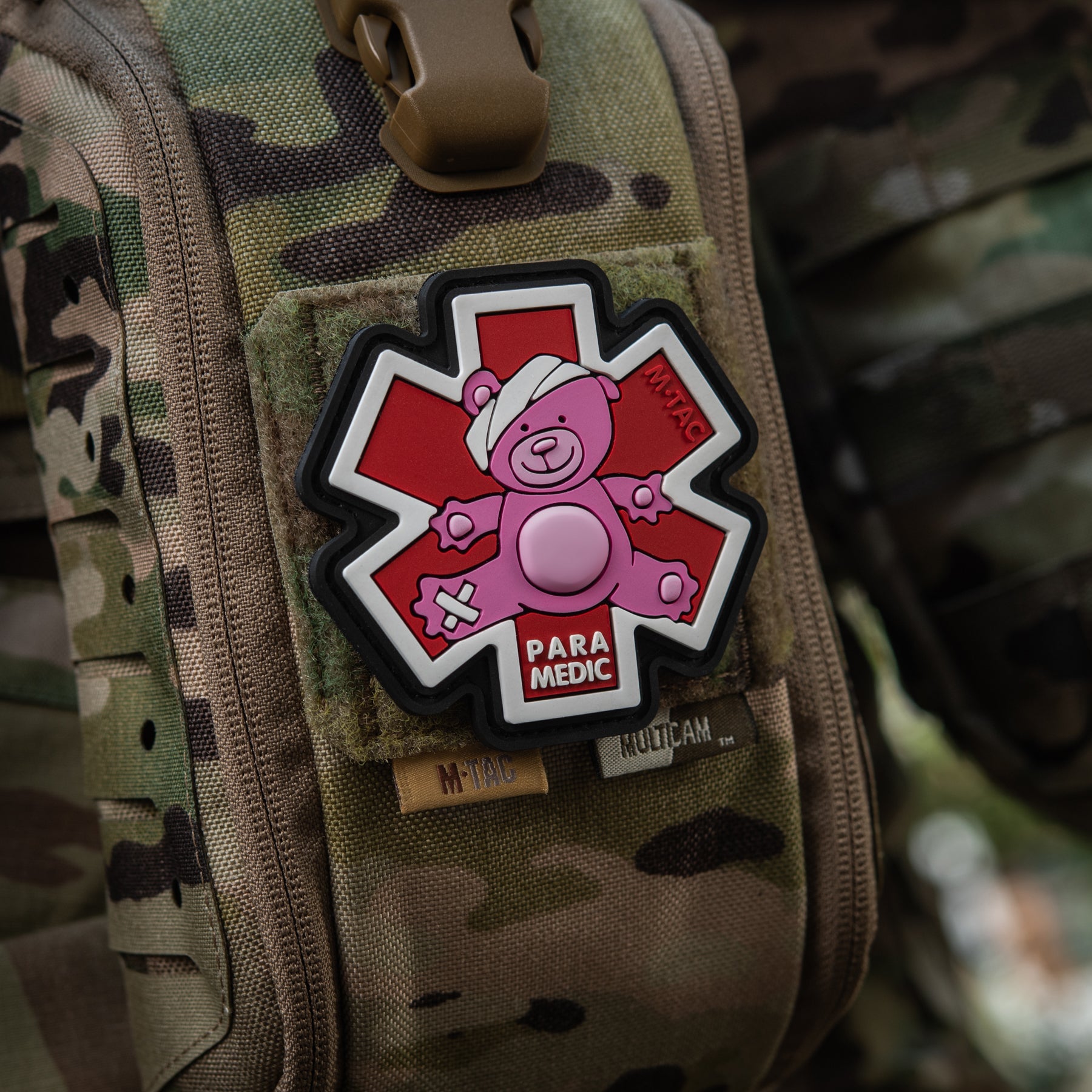 Embroidered M-TAC paramedic bear patch in pink and black on a textured background.