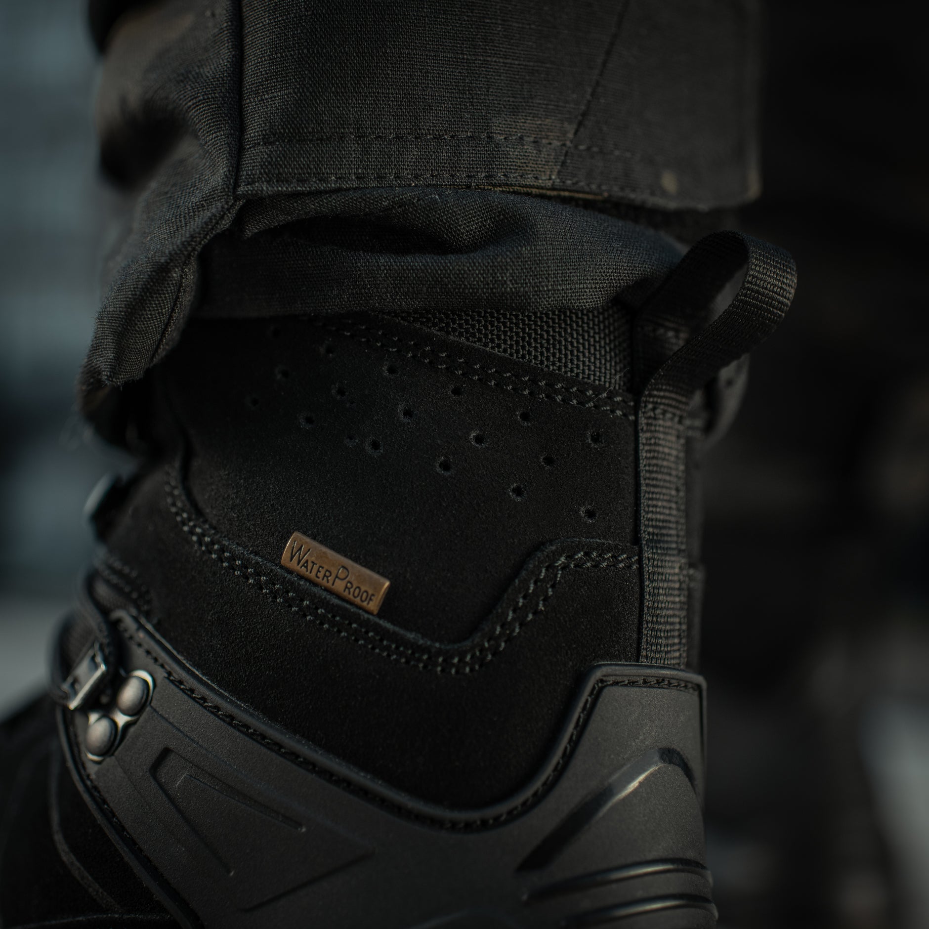 Black M-Tac tactical winter boots with rugged soles and insulated design for cold-weather outdoor activities.