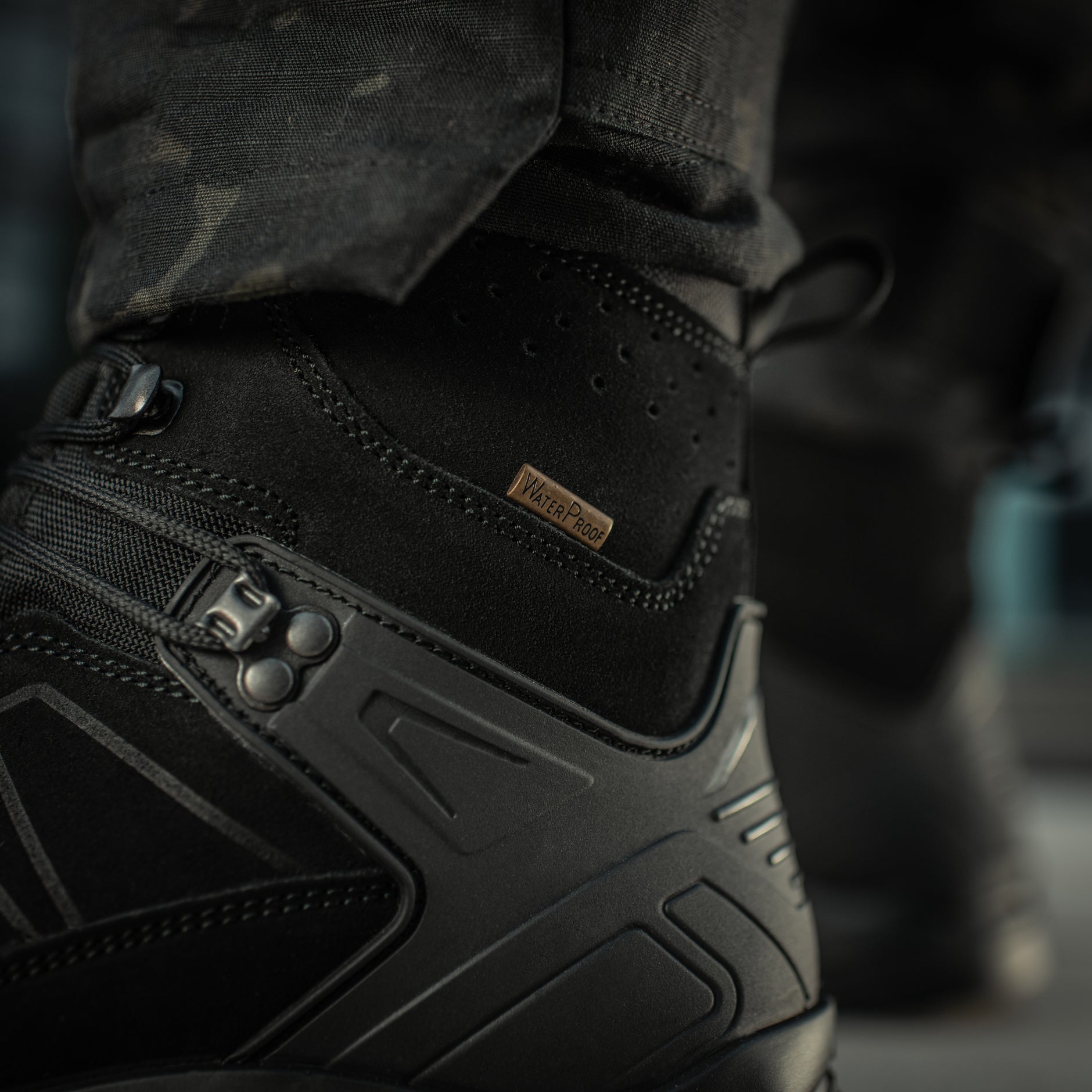 Black M-Tac tactical winter boots with rugged design, durable materials, and sturdy soles for outdoor and tactical use.