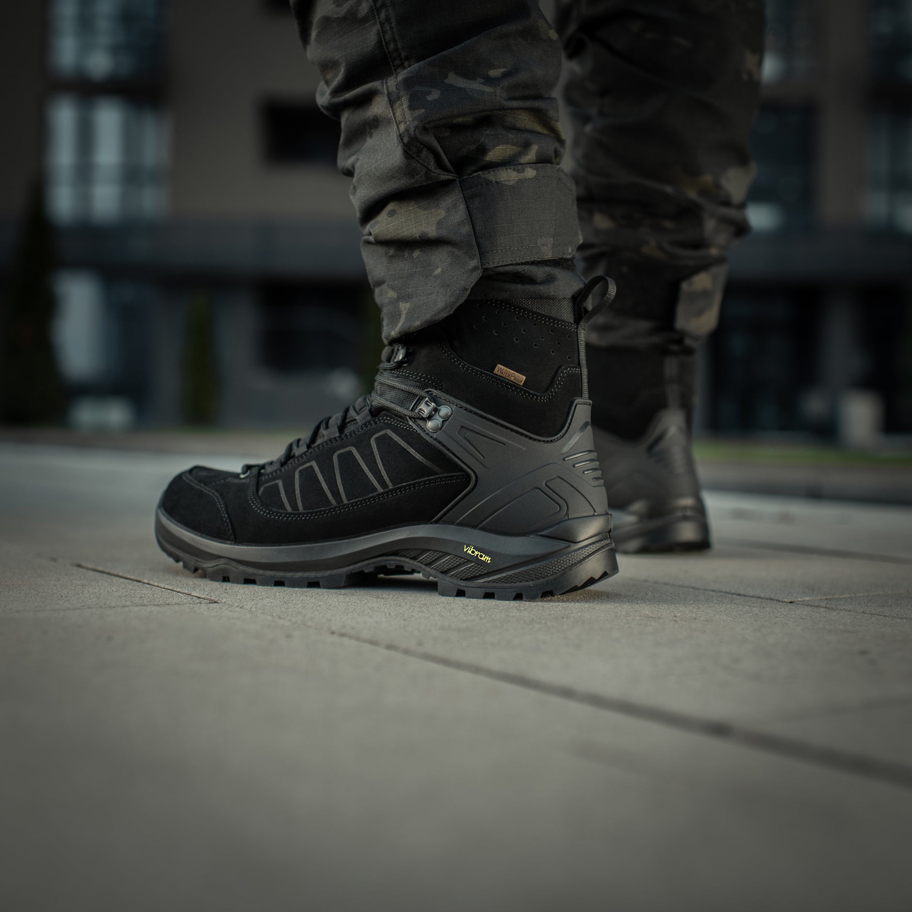 Black M-Tac tactical winter boots with rugged soles and waterproof material, designed for outdoor and tactical use.