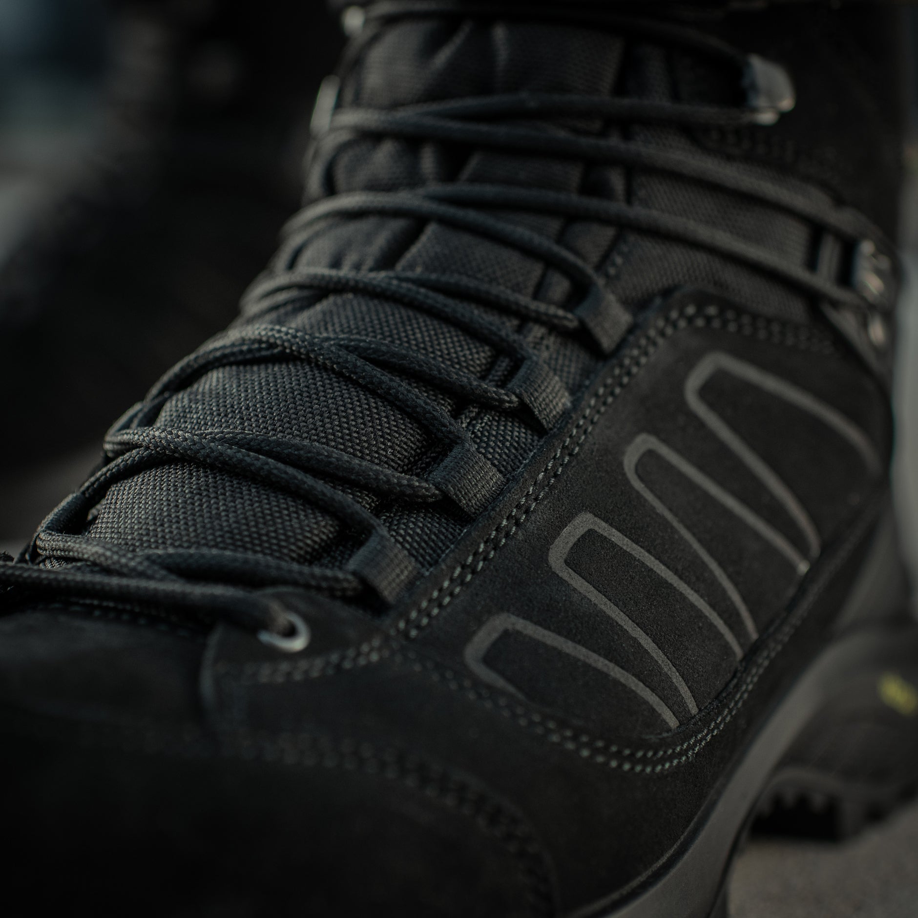 Black M-Tac tactical winter boots with rugged design and sturdy soles, suitable for cold weather outdoor activities.