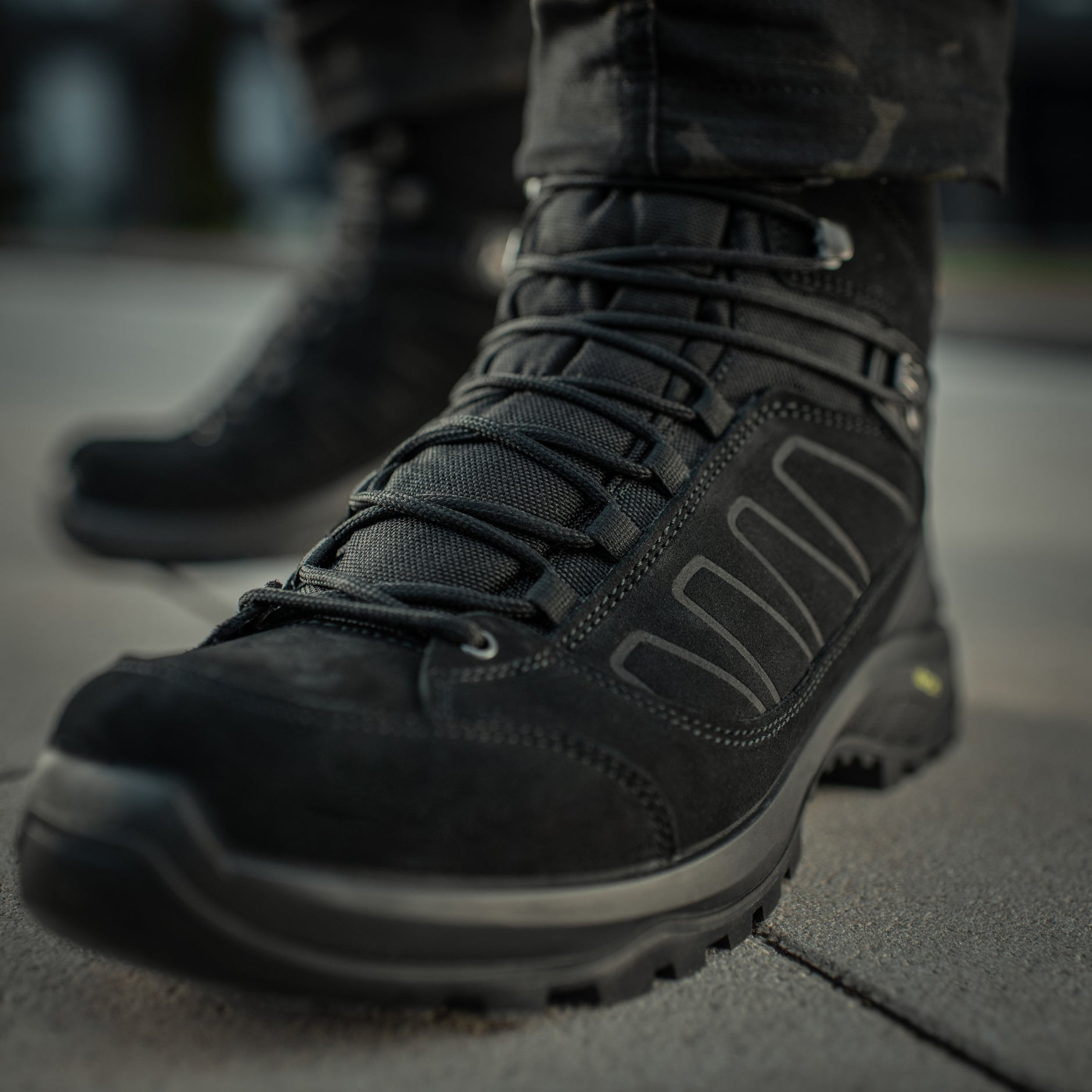 Black M-Tac tactical winter boots with rugged design, thick soles, and reinforced ankle support for outdoor and tactical use.