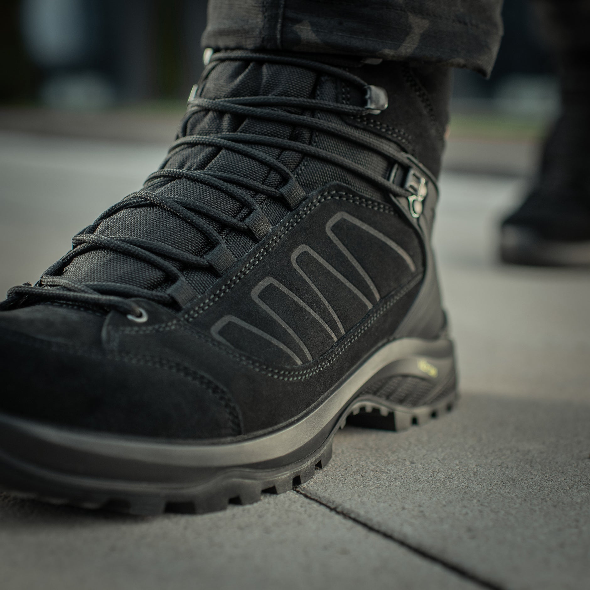 Black M-Tac tactical winter boots with rugged soles and waterproof material, designed for outdoor and tactical use.