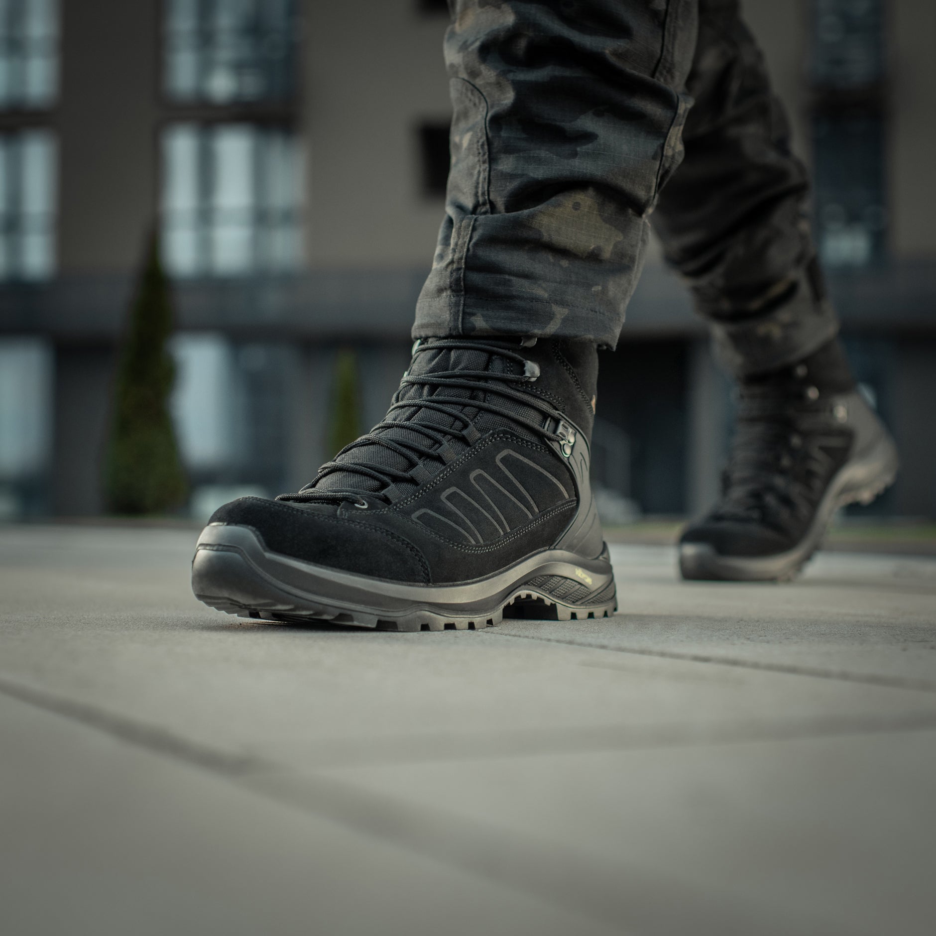 Black M-Tac tactical winter boots with rugged design, sturdy soles, and reinforced ankle support for outdoor and tactical use.
