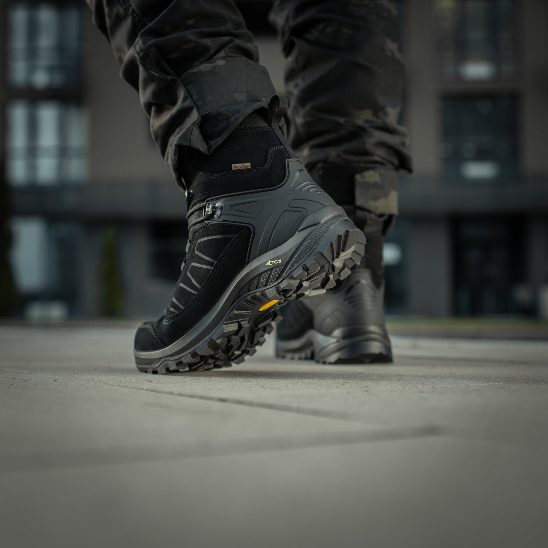 Black M-Tac tactical winter boots with rugged design and sturdy soles, suitable for cold weather and outdoor tactical use.