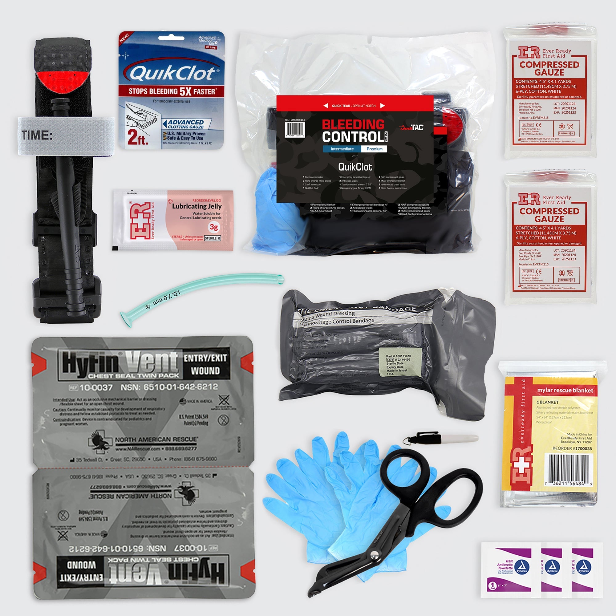 Intermediate MediTac first aid kit with bleeding control pack, CAT tourniquet, bandages, and medical supplies on gray background.