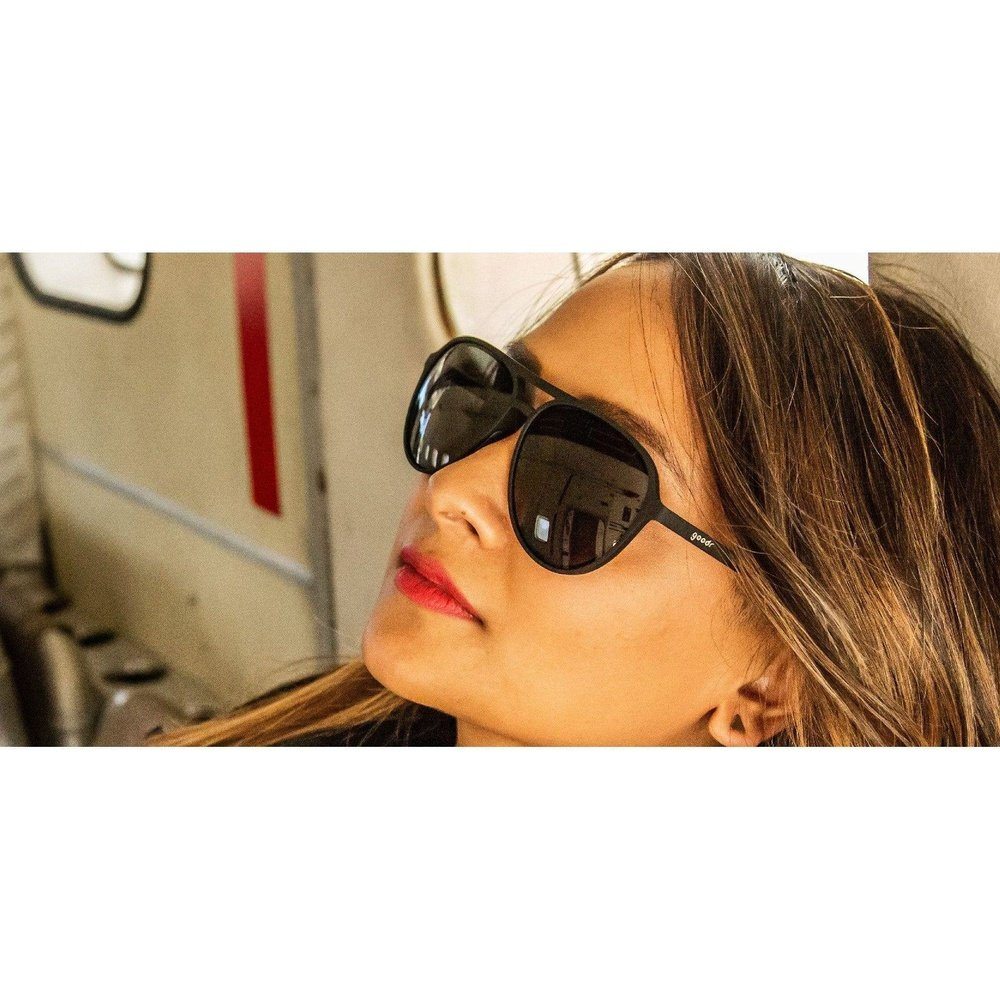 Pair of Rare Air Discs Operation: Blackout MACH G polarized sunglasses with black frames and tinted lenses, outdoor accessory.
