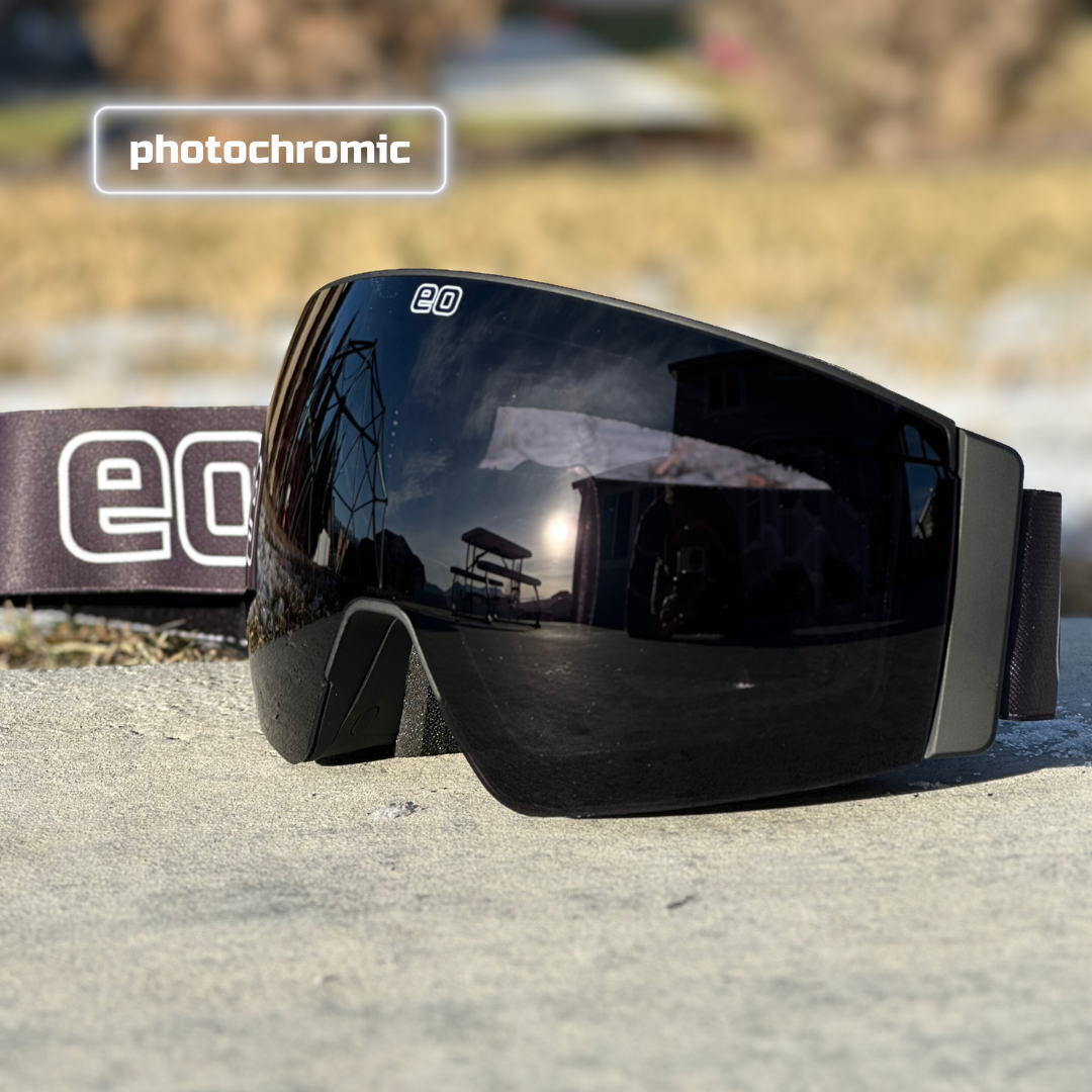 Eastern Outer MACH SCHNELL MAG ski goggles with photochromic lenses, shown at an angle against a snowy background.