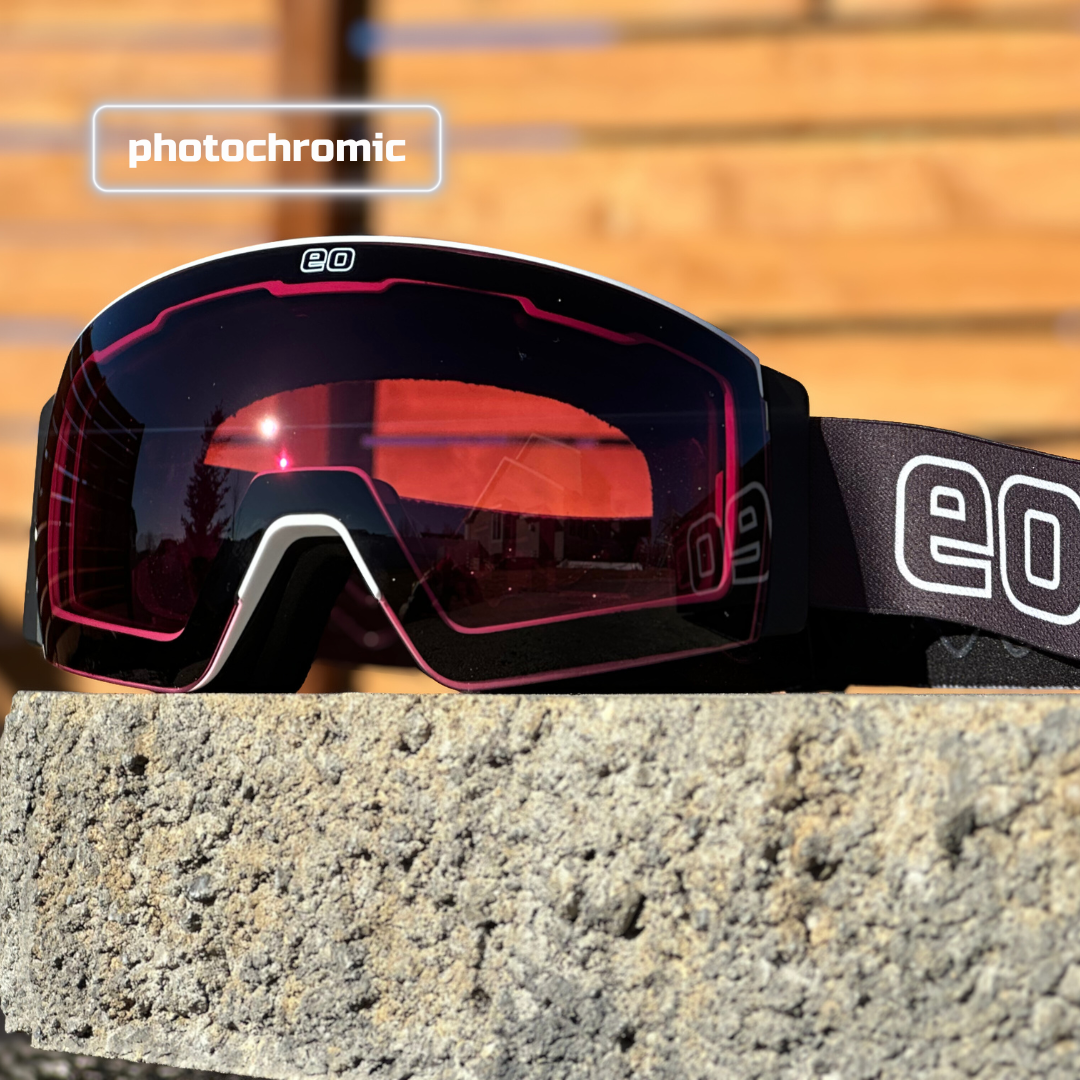 Eastern Outer MACH SCHNELL MAG photochromic ski goggles with black frame and rose lenses on a snowy background.