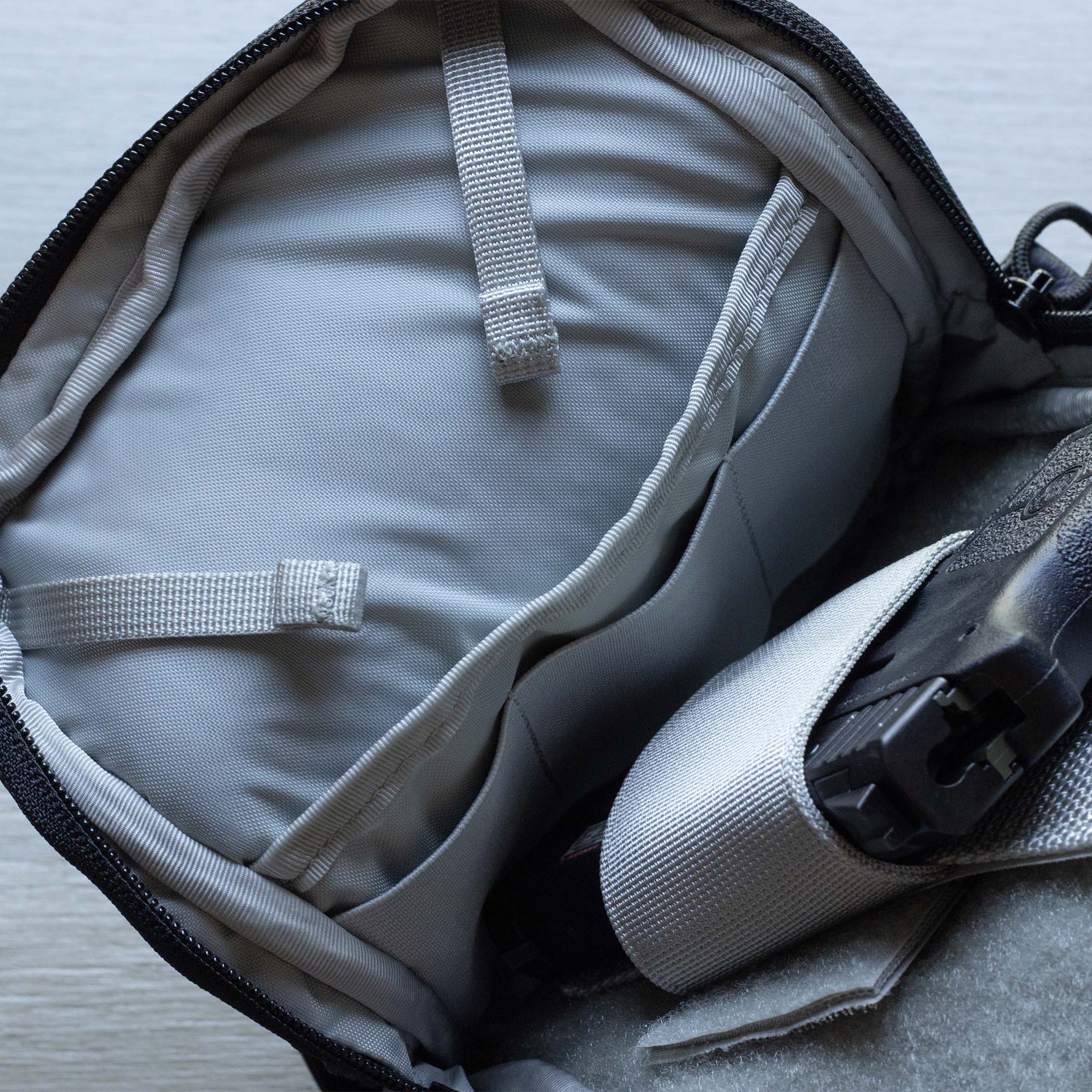 Close-up of Elite Survival Systems Microguard Mini Crossbody concealment pouch with integrated mag loops for secure firearm storage.
