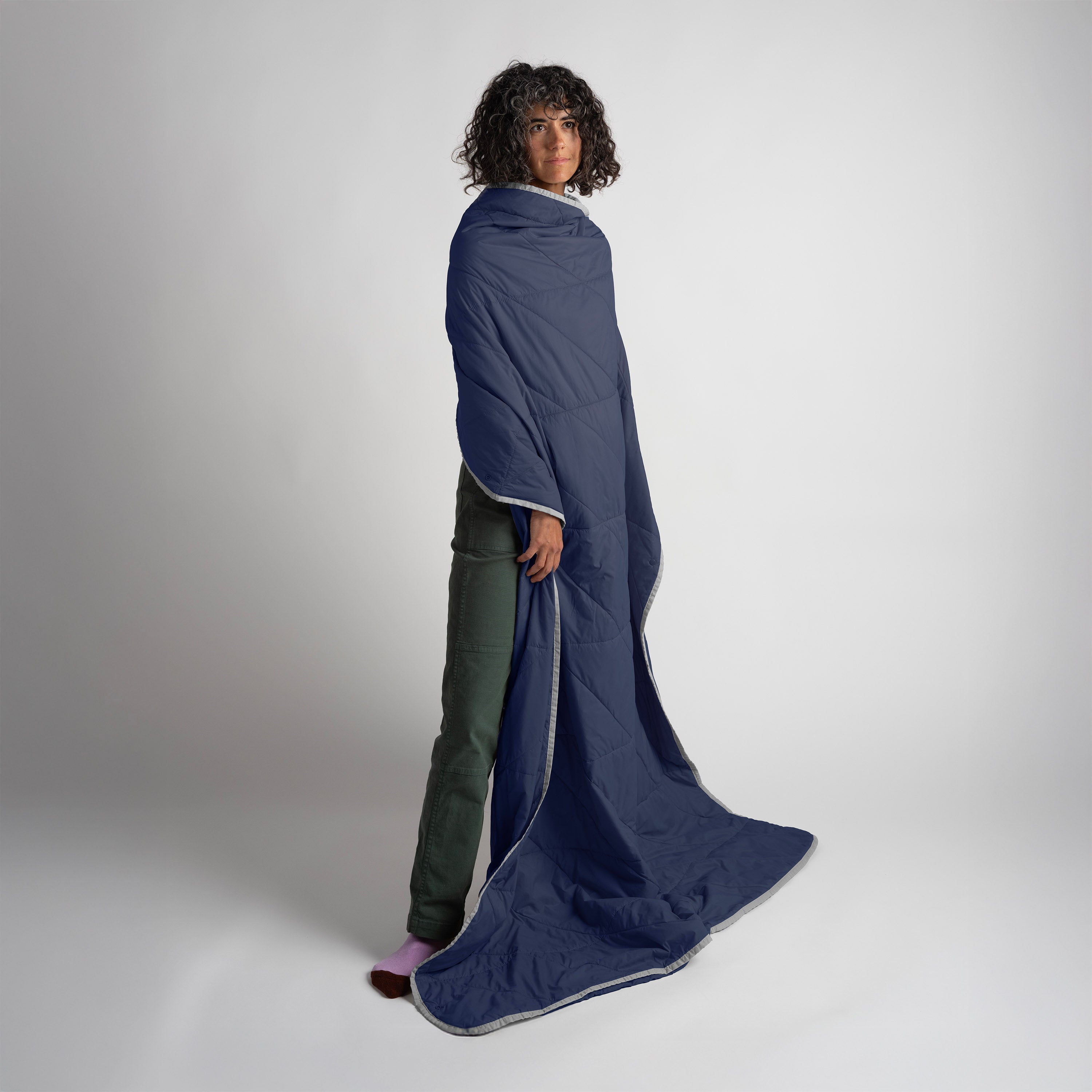 Gray Gravel Layover™ XL travel blanket in soft blue fabric, spread out showing its plush, cozy texture for comfort during travel.
