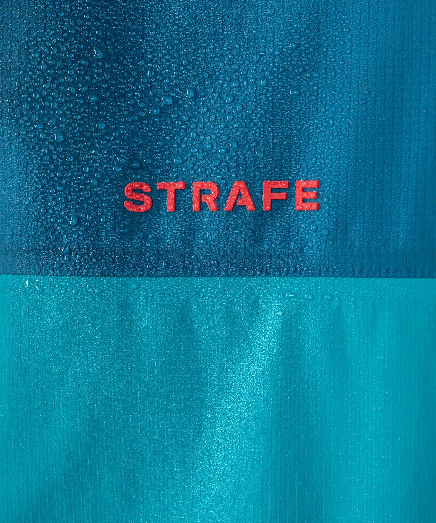 Strafe Outerwear Meadow 3L Shell Jacket in dark teal, showcasing waterproof fabric and adjustable hood design.