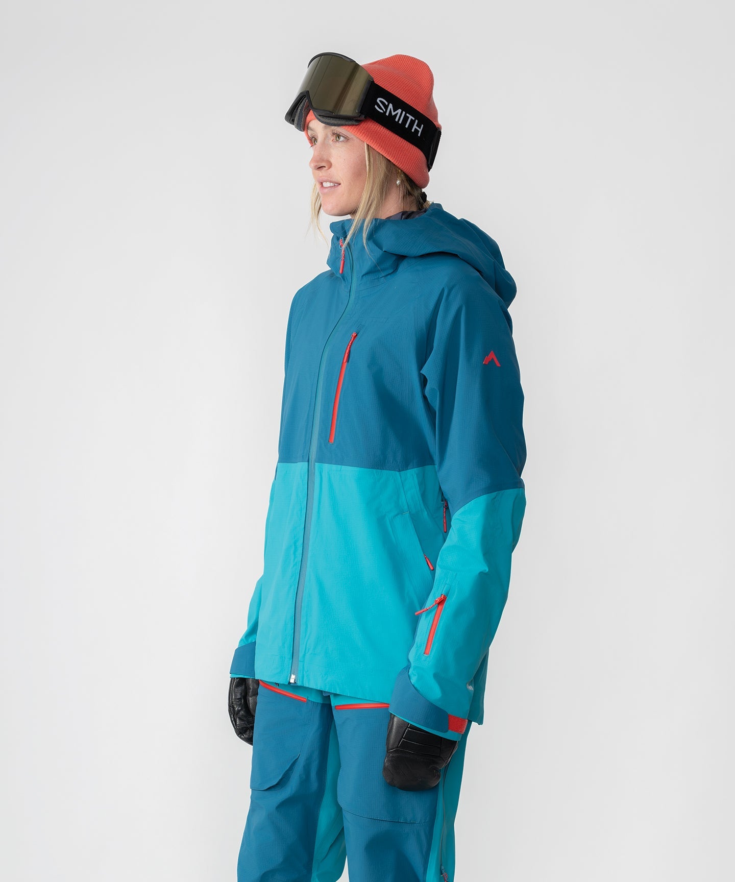 Dark teal Strafe Outerwear Meadow 3L shell jacket with a sleek design and adjustable features for outdoor activities.