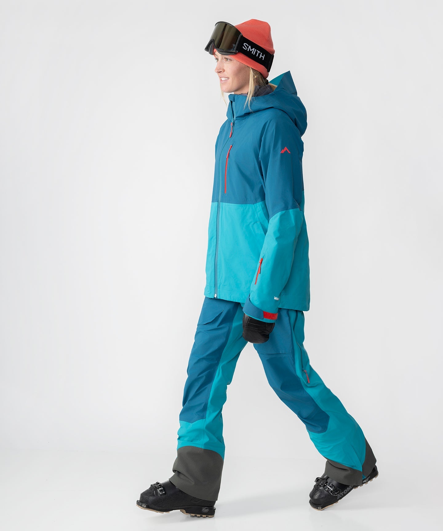 Dark teal Strafe Outerwear Meadow 3L shell jacket with a hood, showcasing its waterproof fabric and sleek design.