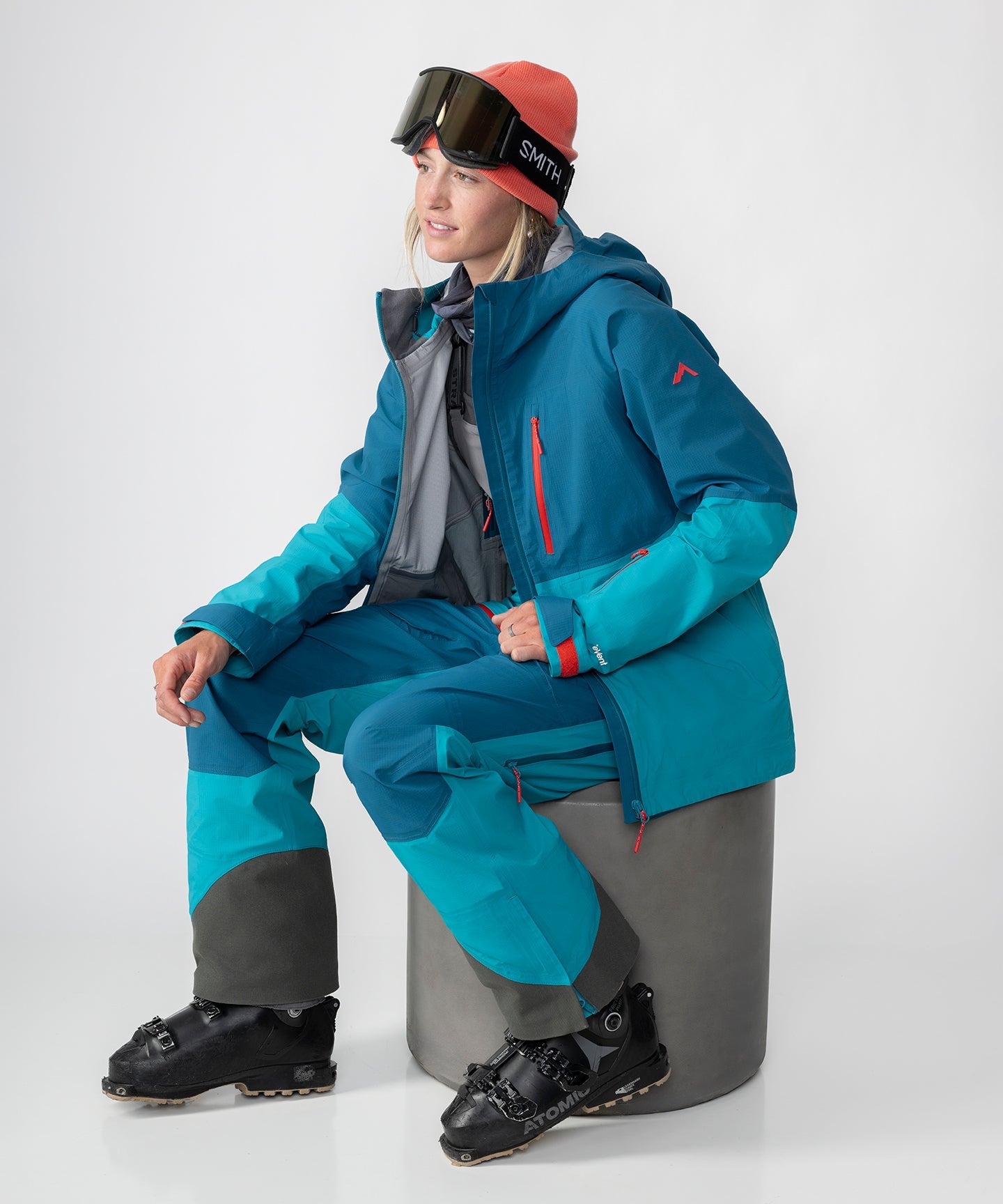 Dark teal Strafe Outerwear Meadow 3L shell jacket with a hood, showcasing waterproof fabric and ventilation features.