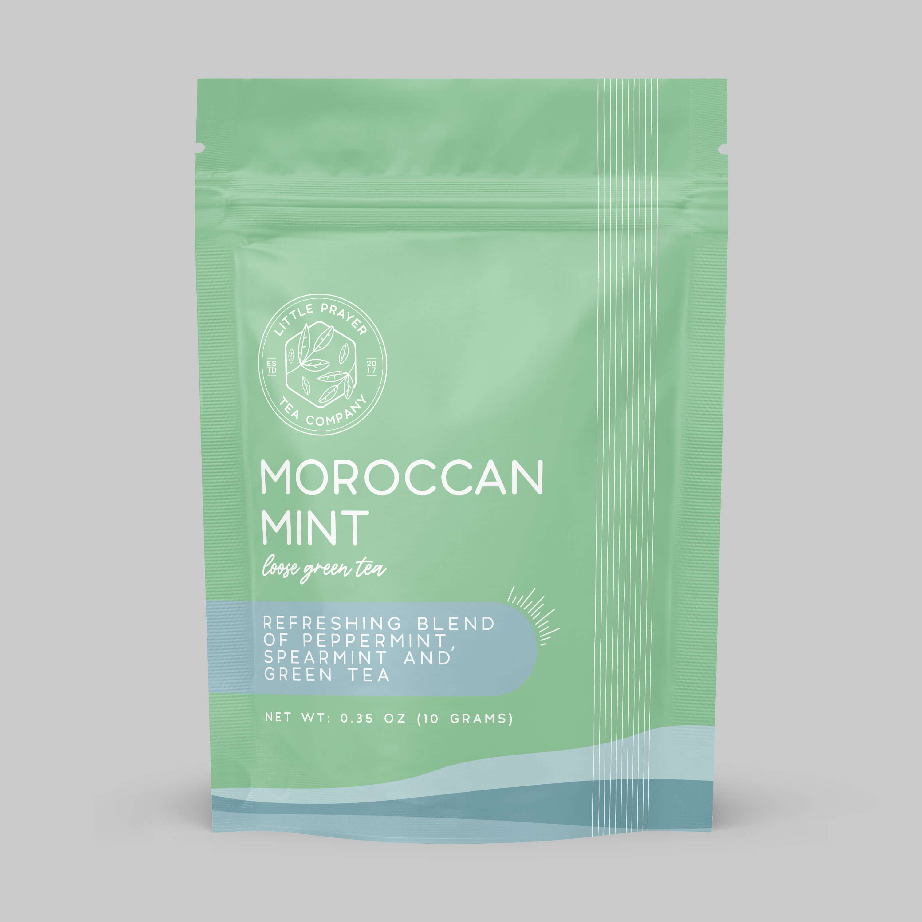 Sample of Moroccan mint tea from Little Prayer Tea Company, featuring fresh mint leaves and brewed tea in a glass cup.