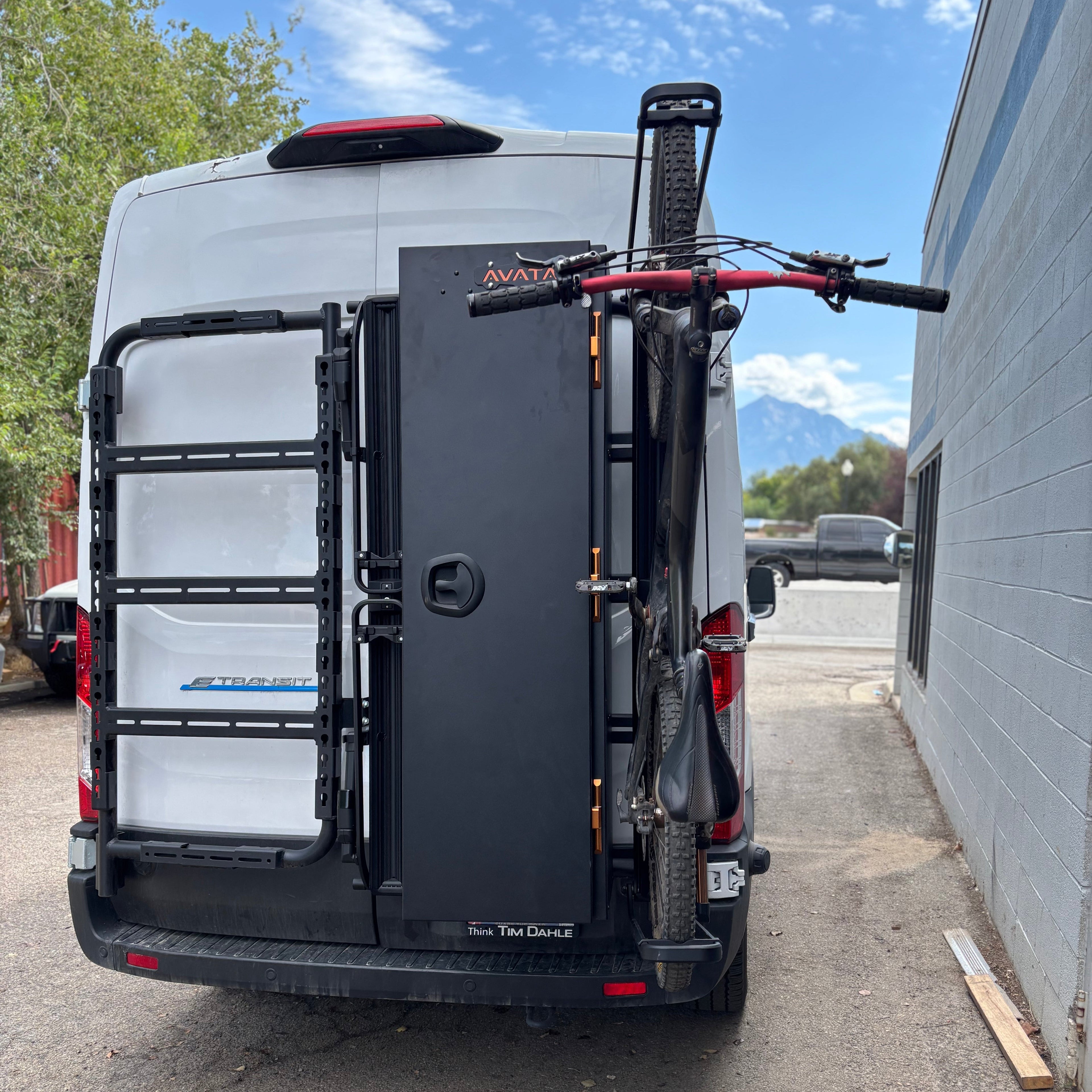 Avatar Offroad Avatar Centi Van Storage Box mounted on a mountain bike van for organized outdoor gear storage.
