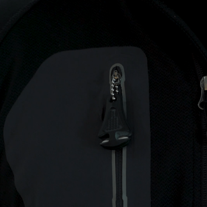 Green Line Cutterz ceramic blade zipper pull attached to a zip-up jacket for easy access and functionality.