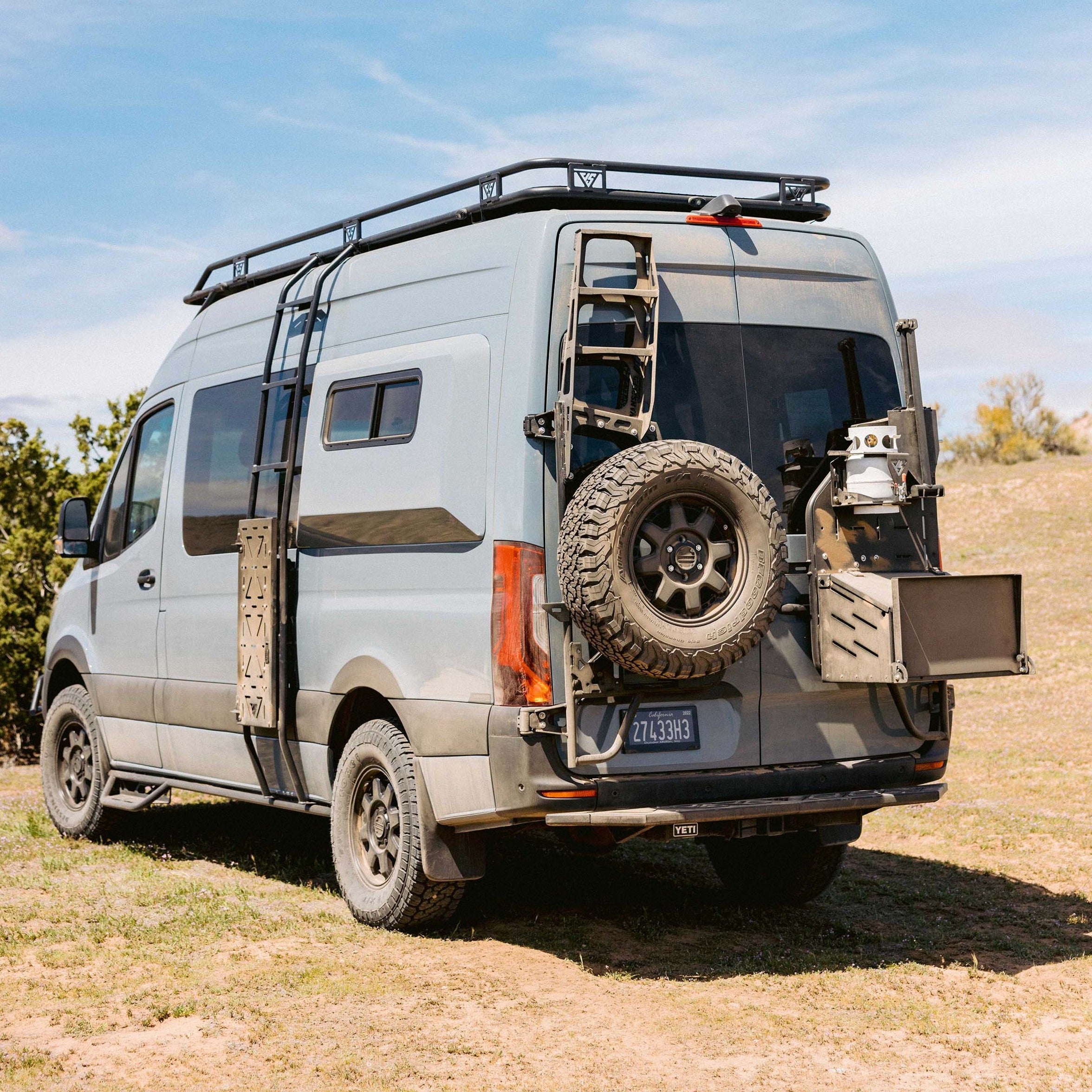 The Van Mart Sprinter Mule Pack Shovel Mount Set installed on a van, showcasing durable exterior parts for outdoor use.