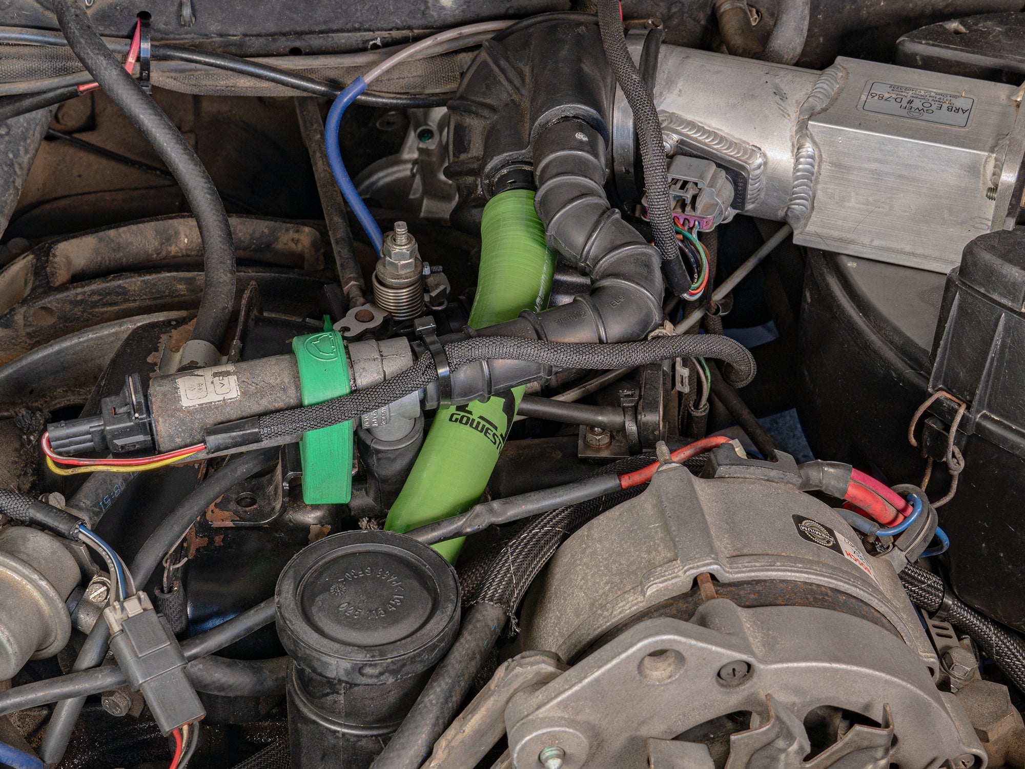 GoWesty crankcase breather tower hose installed, flexible black rubber hose connecting components in a vehicle engine system