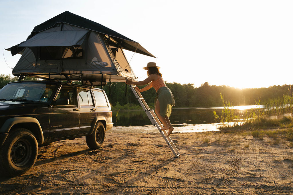 Backcountry Sportsman Napier rooftop tent set up on a vehicle, featuring sturdy fabric, open windows, and a spacious interior for camping.